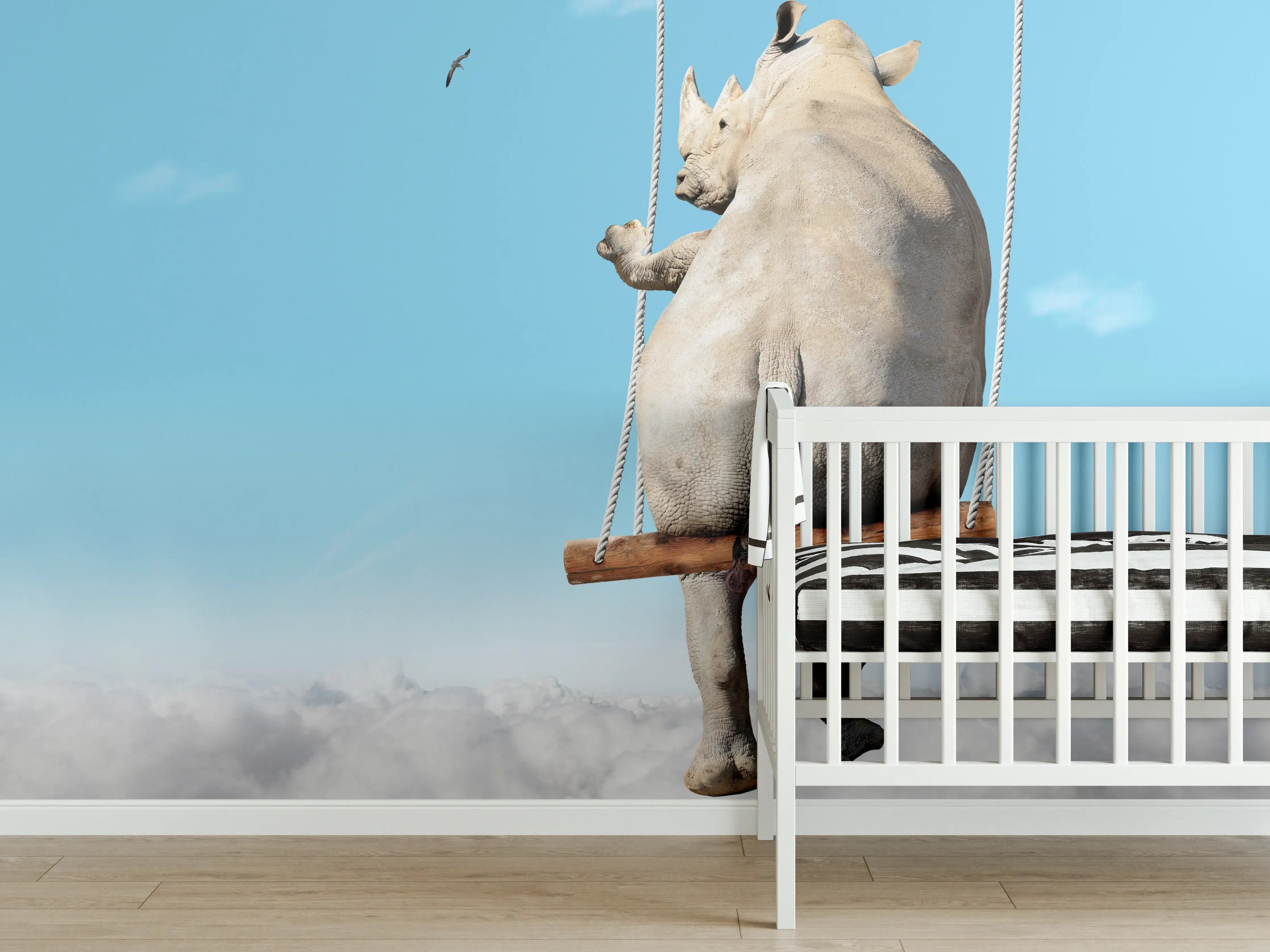 Babyzimmer Wandgestaltung - Nashorn schaukelt über den Wolken