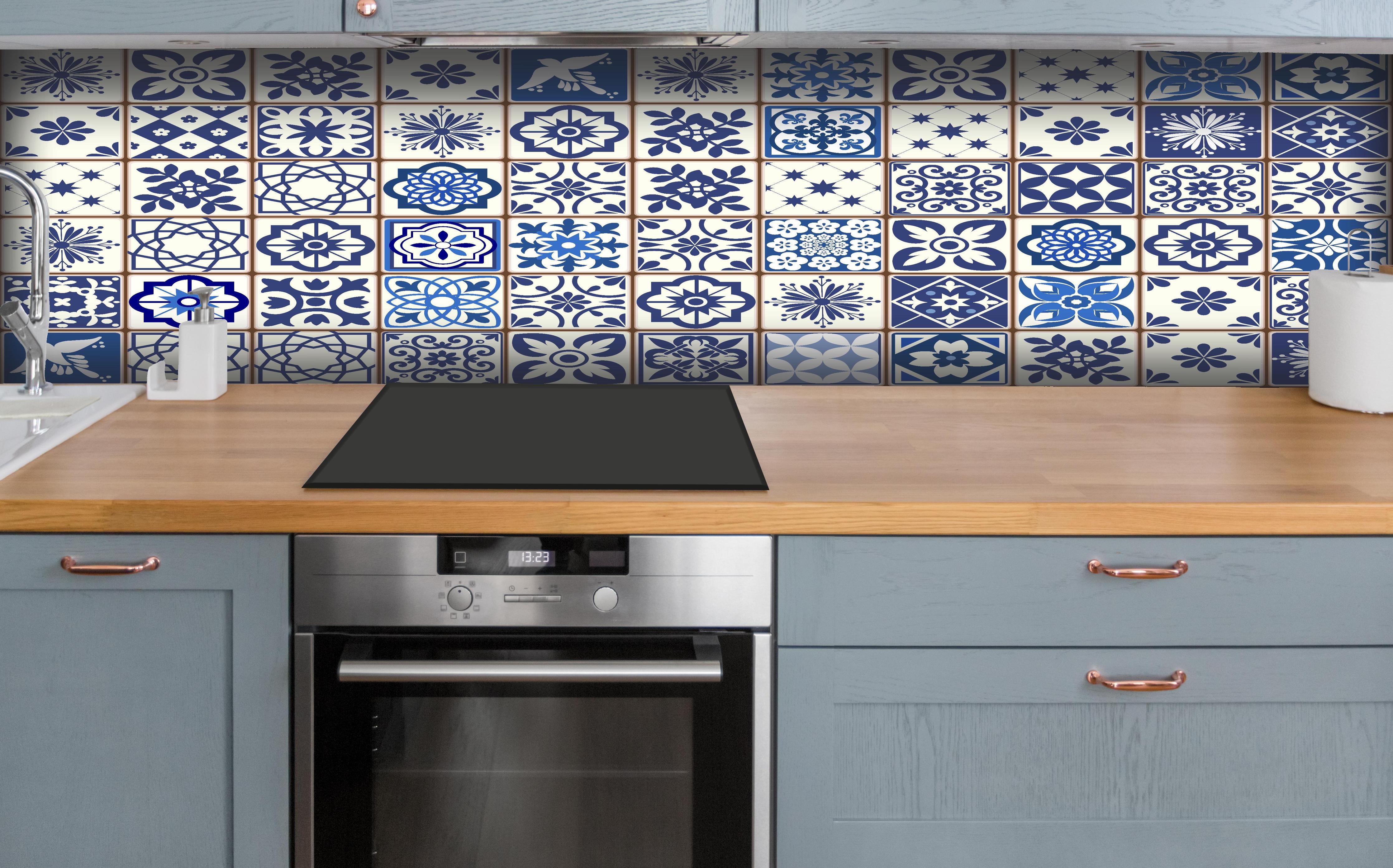 Küche - Diverse Blau-Weiße Kachelmuster Designs hinter weißen Hochglanz-Küchenregalen und schwarzem Wasserhahn