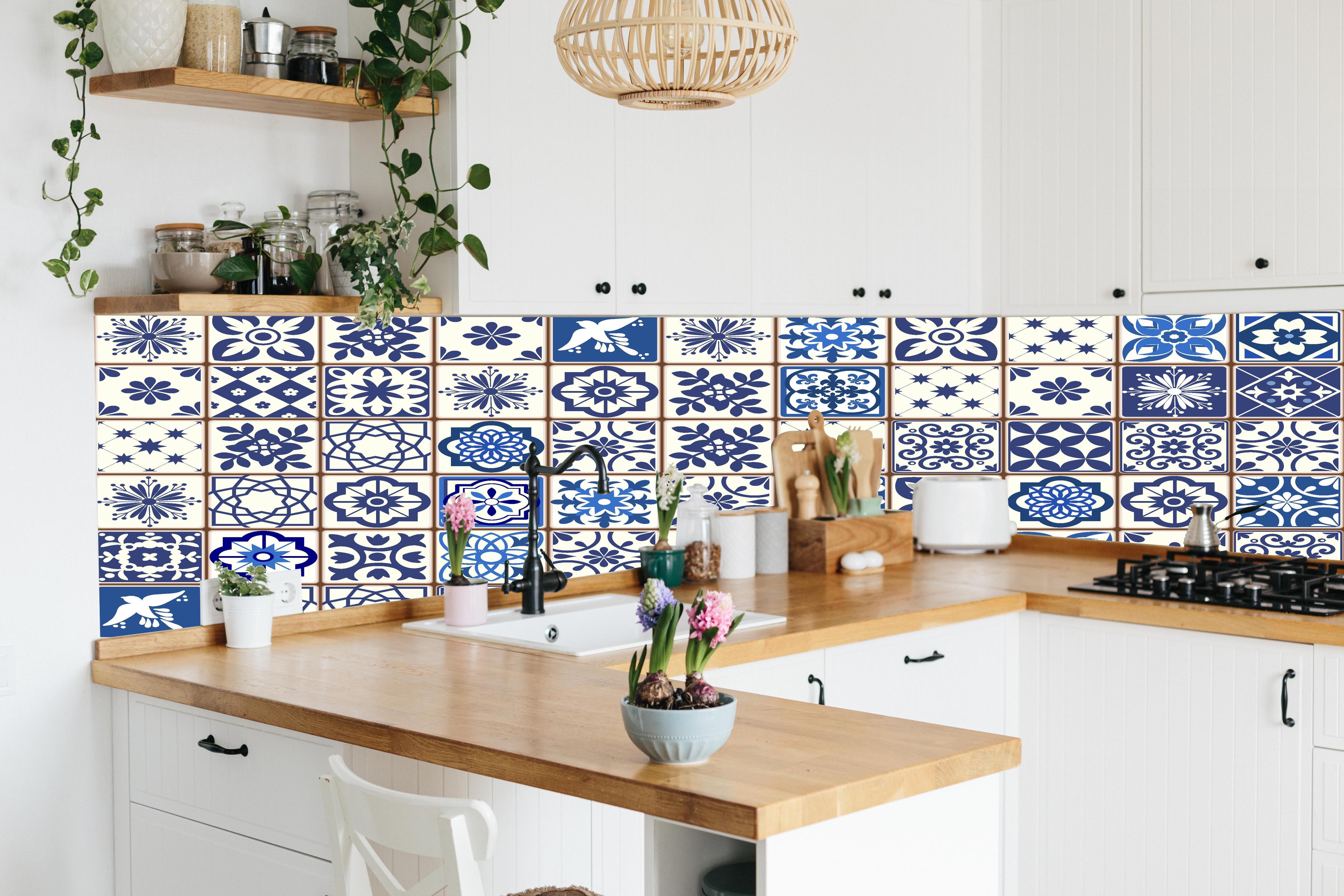 Küche - Diverse Blau-Weiße Kachelmuster Designs hinter weißen Hochglanz-Küchenregalen und schwarzem Wasserhahn