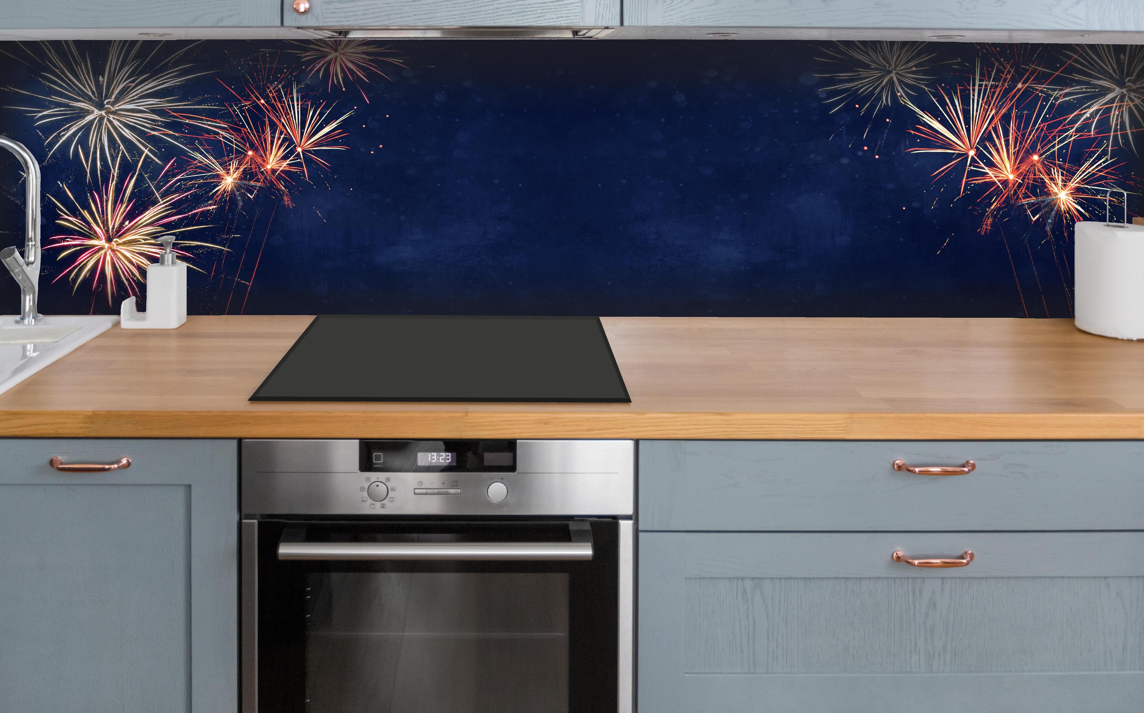 Küche - Farbenfrohes Feuerwerk zu Neujahr 2023 hinter weißen Hochglanz-Küchenregalen und schwarzem Wasserhahn