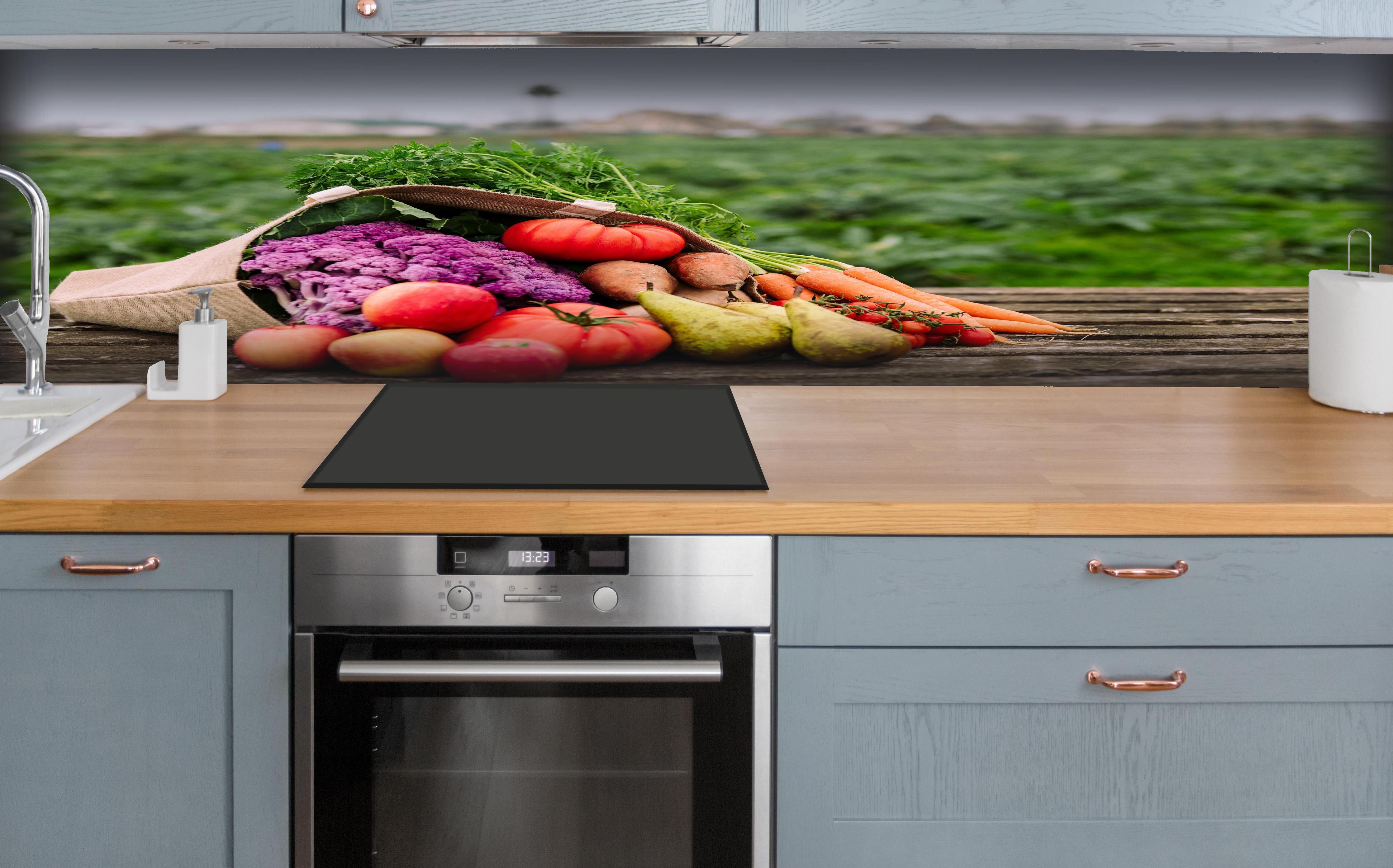 Küche - Frische Bio-Ernte in Bunt hinter weißen Hochglanz-Küchenregalen und schwarzem Wasserhahn