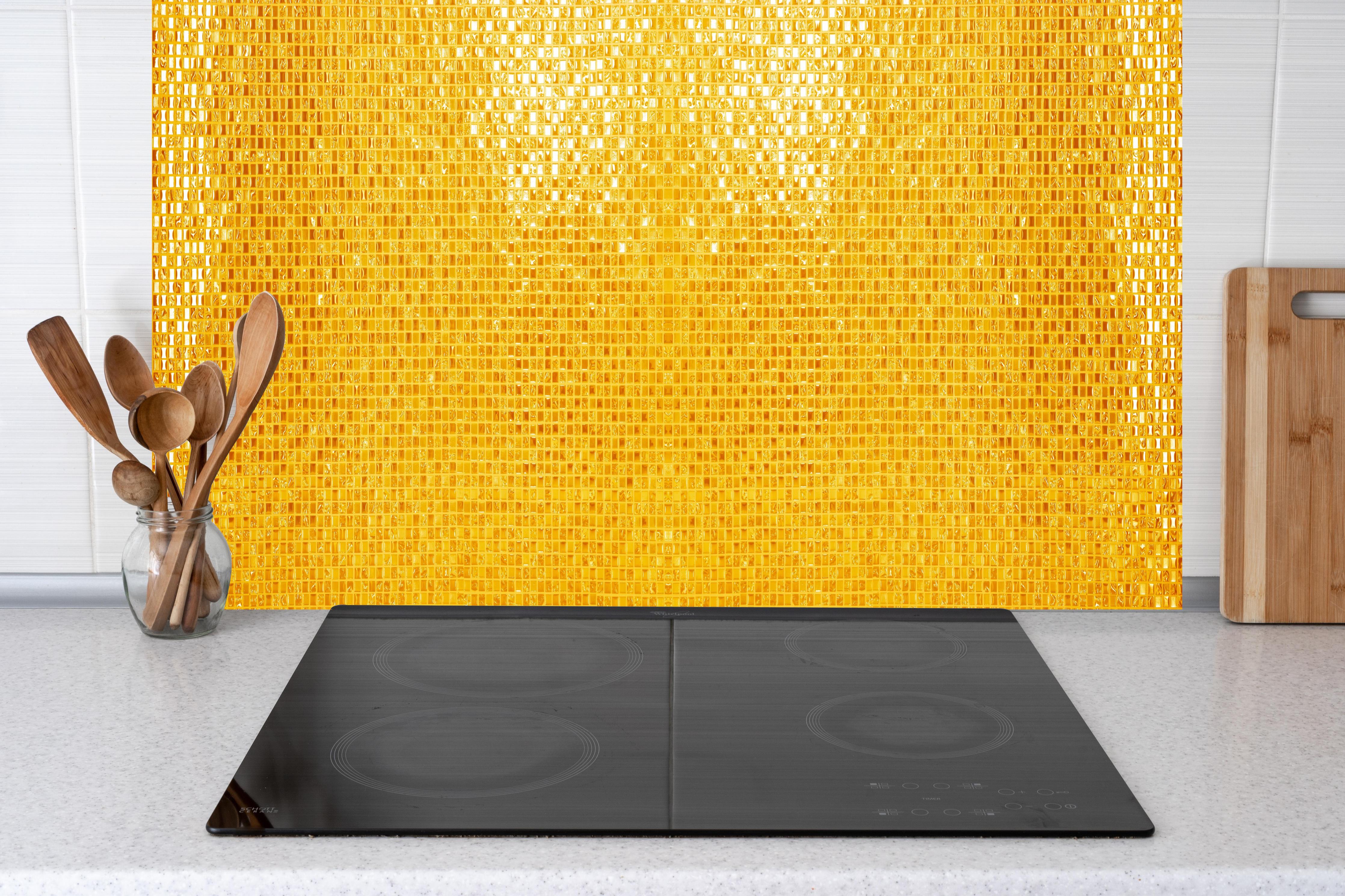 Küche - Goldgelbe Mosaikfliesen hinter weißen Hochglanz-Küchenregalen und schwarzem Wasserhahn