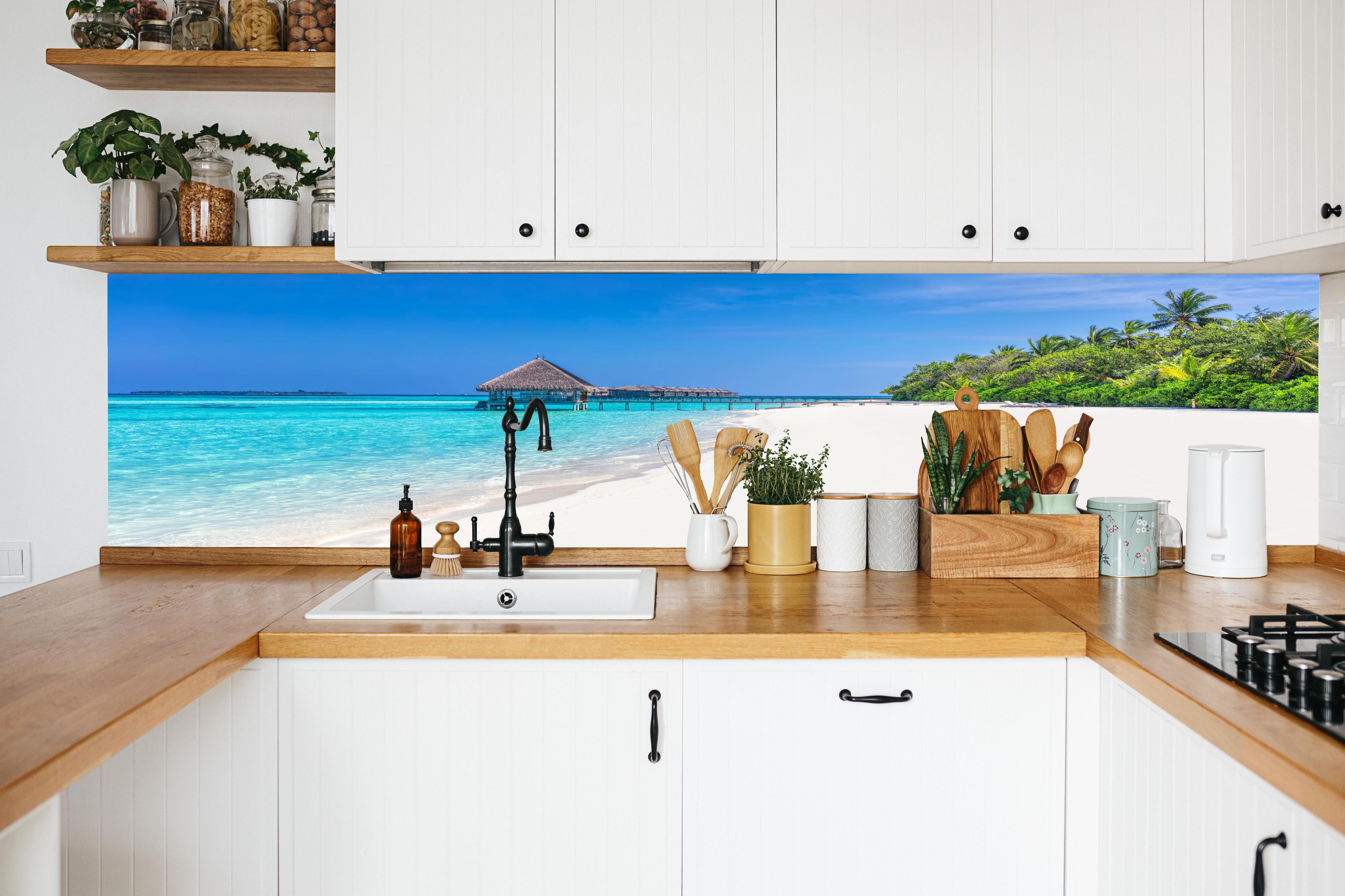 Küche - Idyllisches tropisches Paradies mit türkisblauem Wasser und weißem Sandstrand hinter weißen Hochglanz-Küchenregalen und schwarzem Wasserhahn