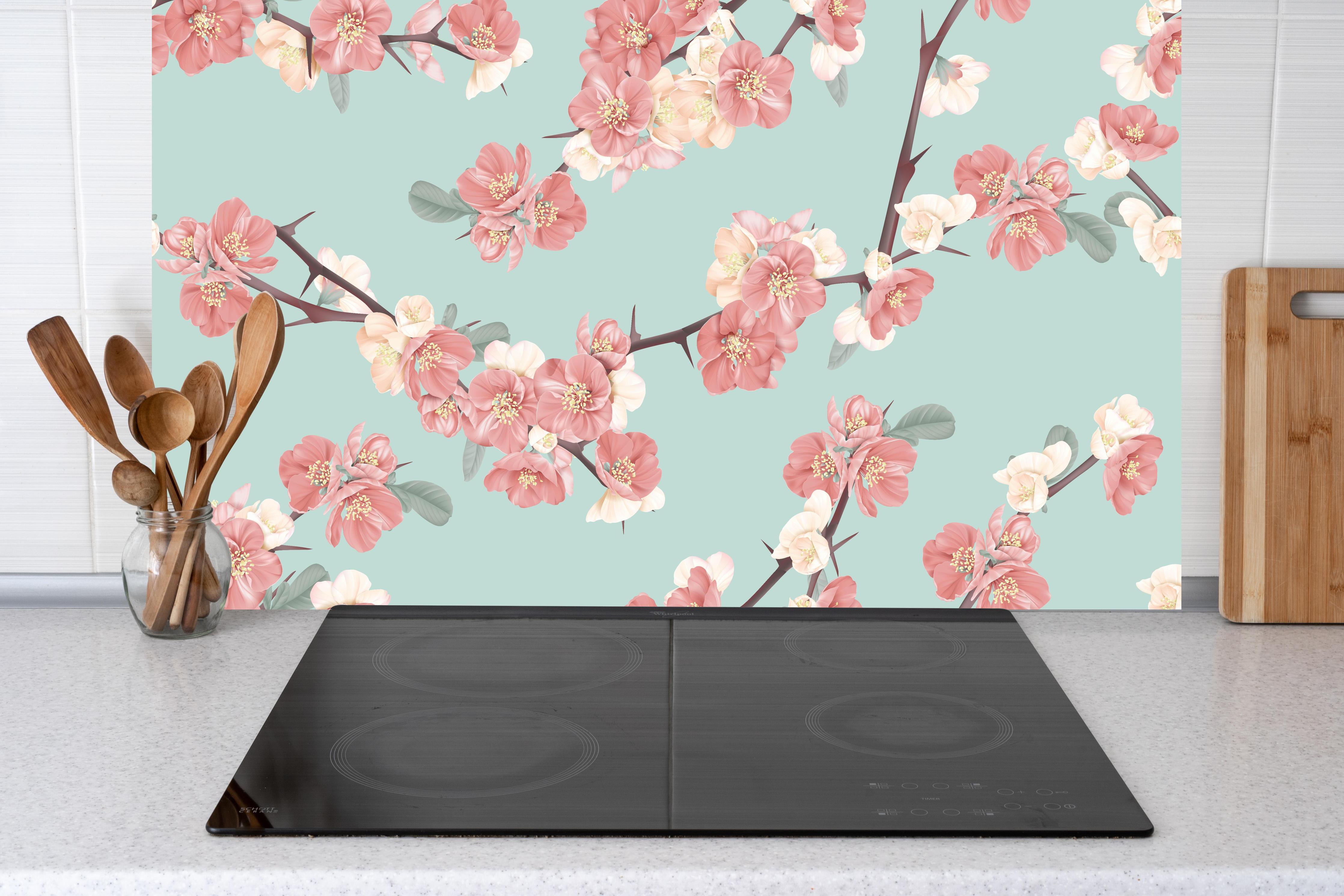 Küche - Japanische Quittenblüte auf Pastellblau hinter weißen Hochglanz-Küchenregalen und schwarzem Wasserhahn