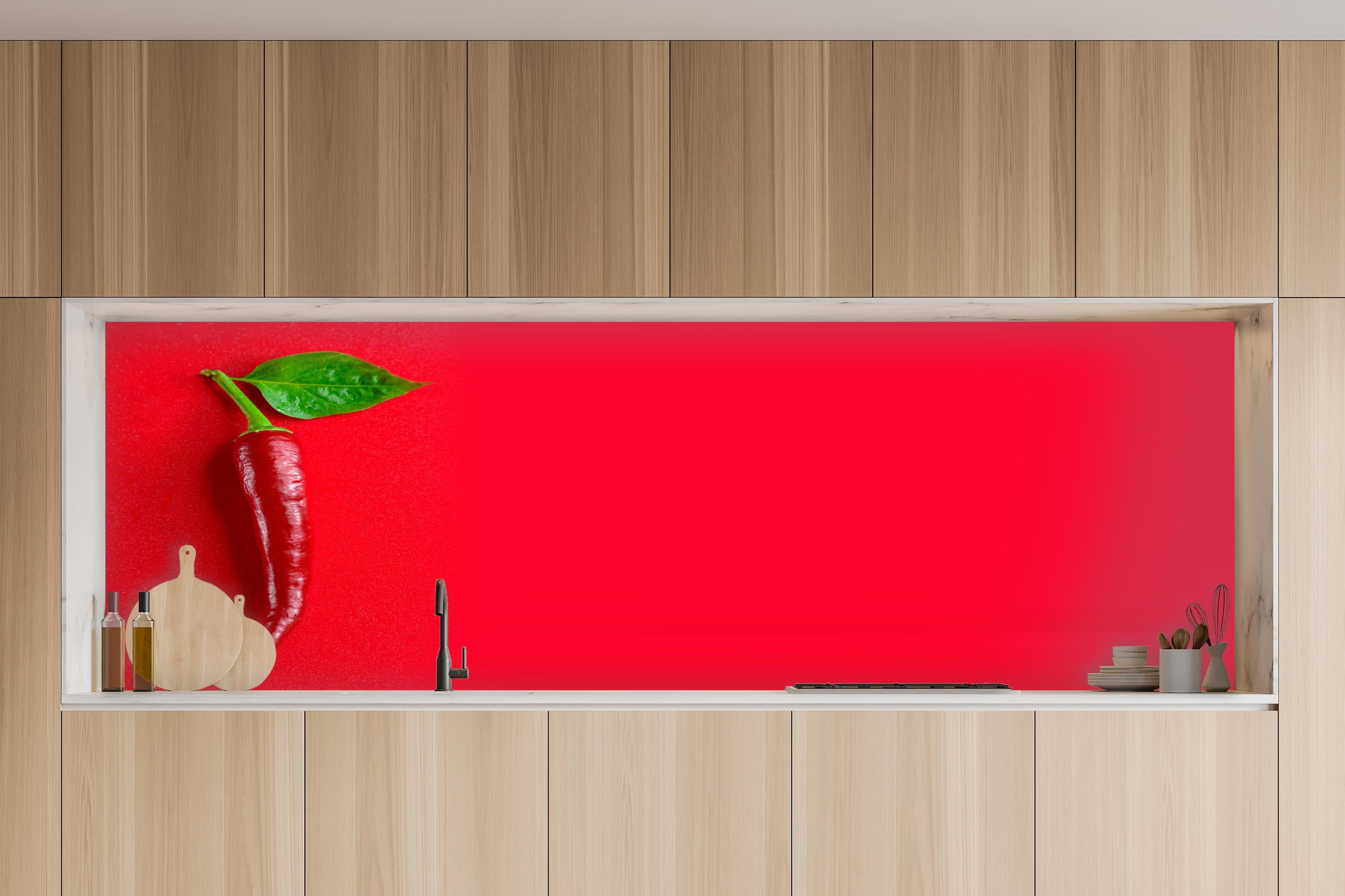 Küche - Rote Chili mit grünem Blatt in charakteristischer Vollholz-Küche mit modernem Gasherd