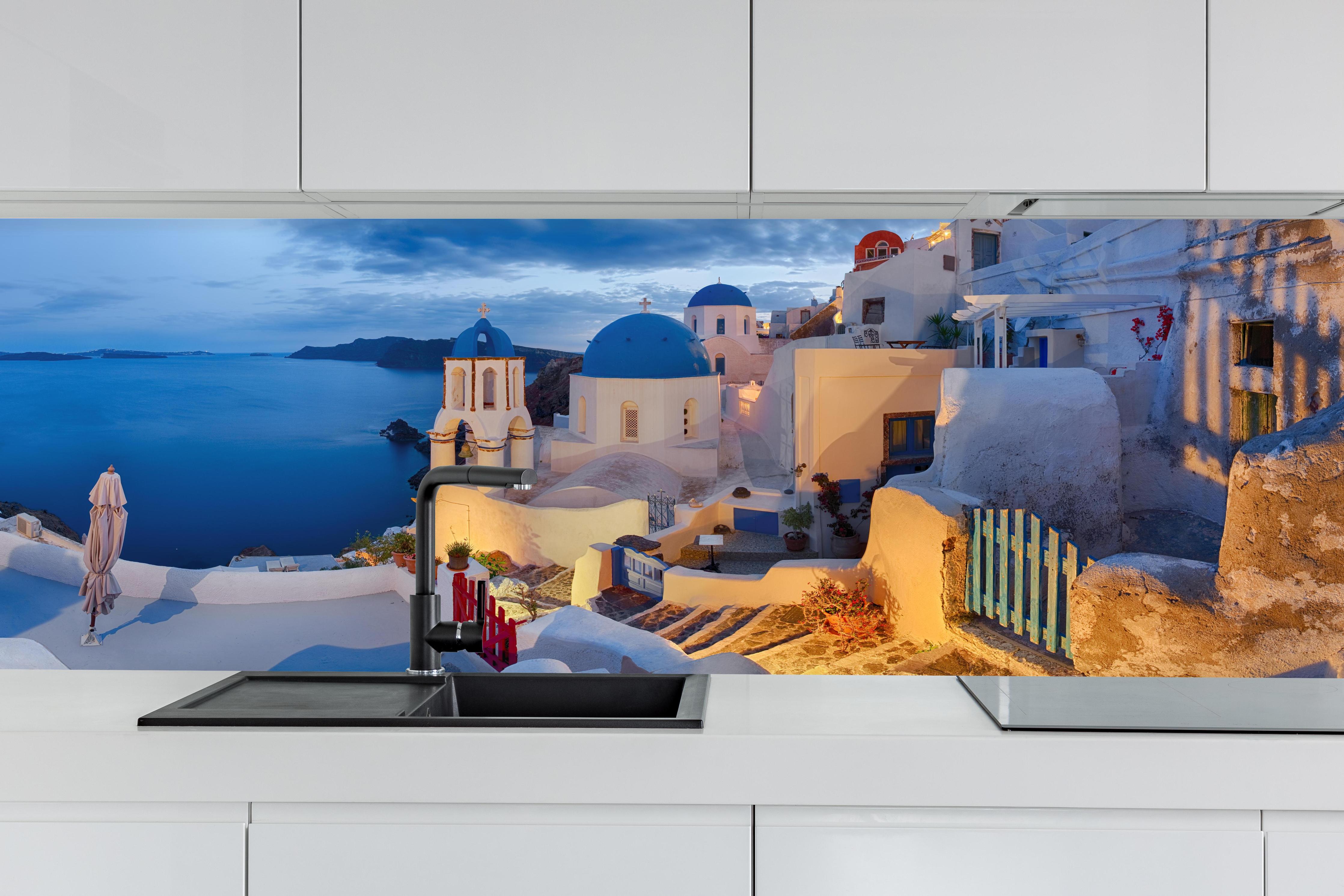 Küche - Santorini Skyline in Blau und Weiß hinter weißen Hochglanz-Küchenregalen und schwarzem Wasserhahn