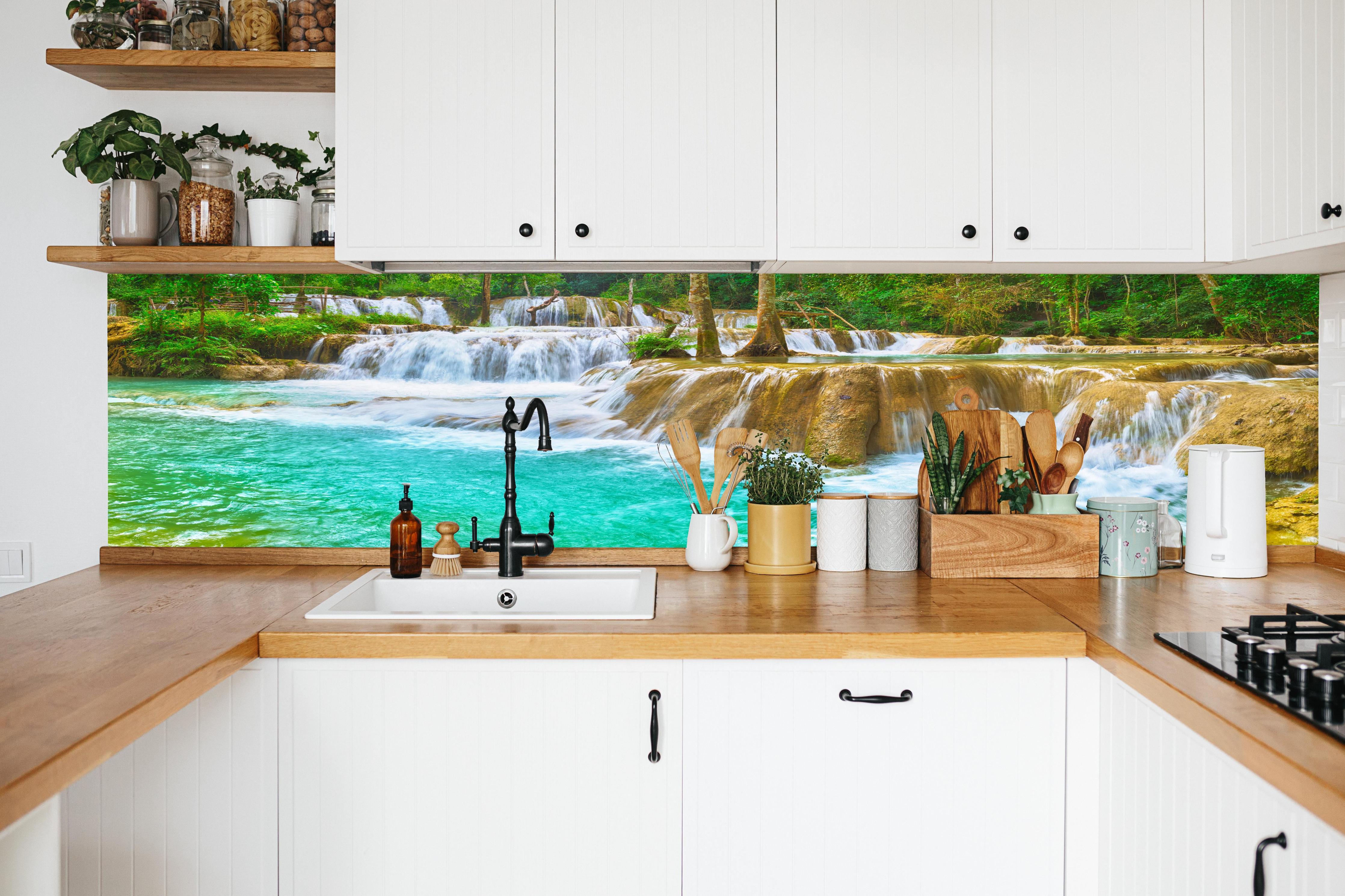 Küche - Türkisgrüner Stufen-Wasserfall in weißer Küche hinter Gewürzen und Kochlöffeln aus Holz