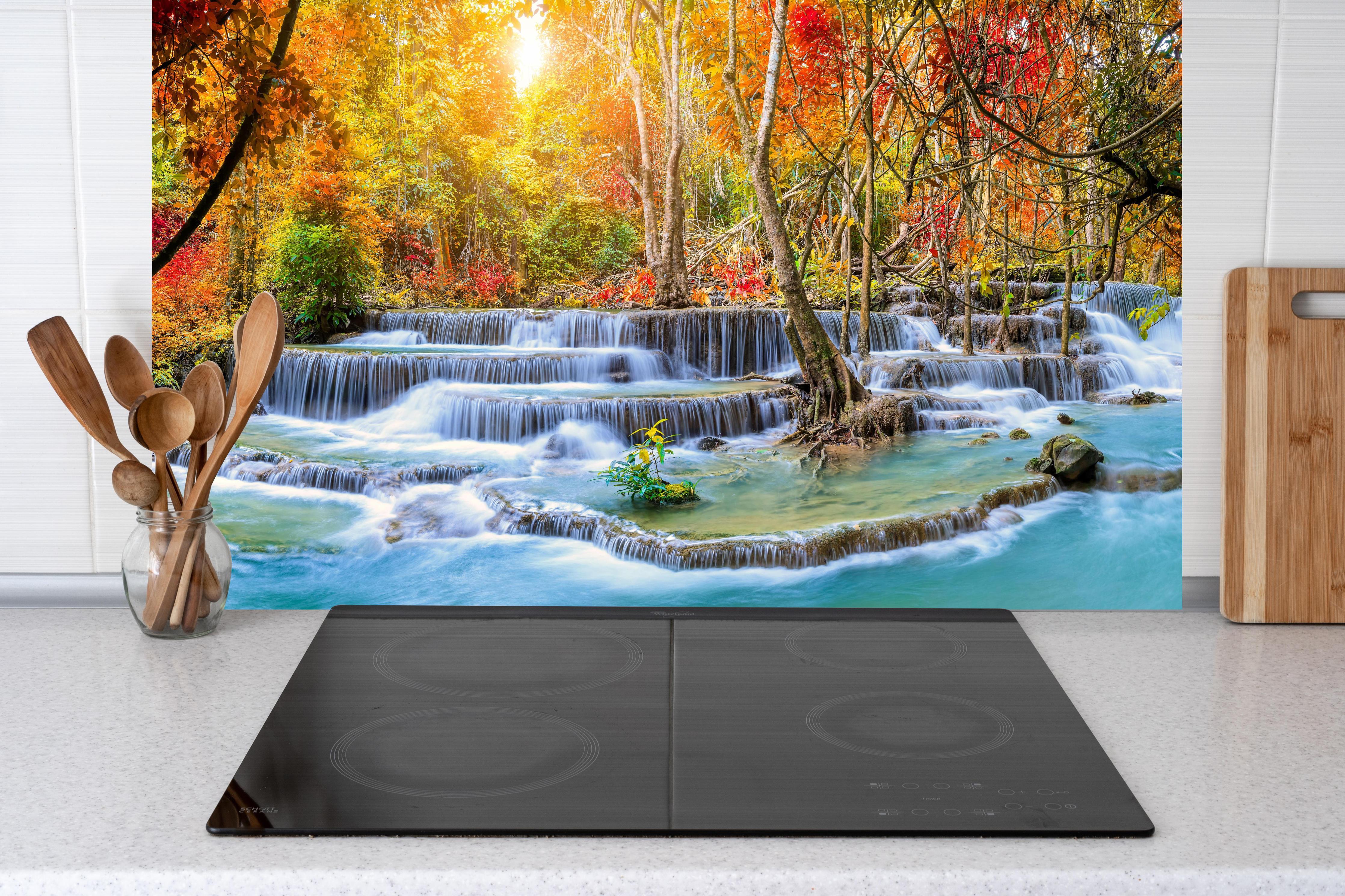 Küche - Wasserfall im Wald Thailand Nationalparks hinter Cerankochfeld und Holz-Kochutensilien