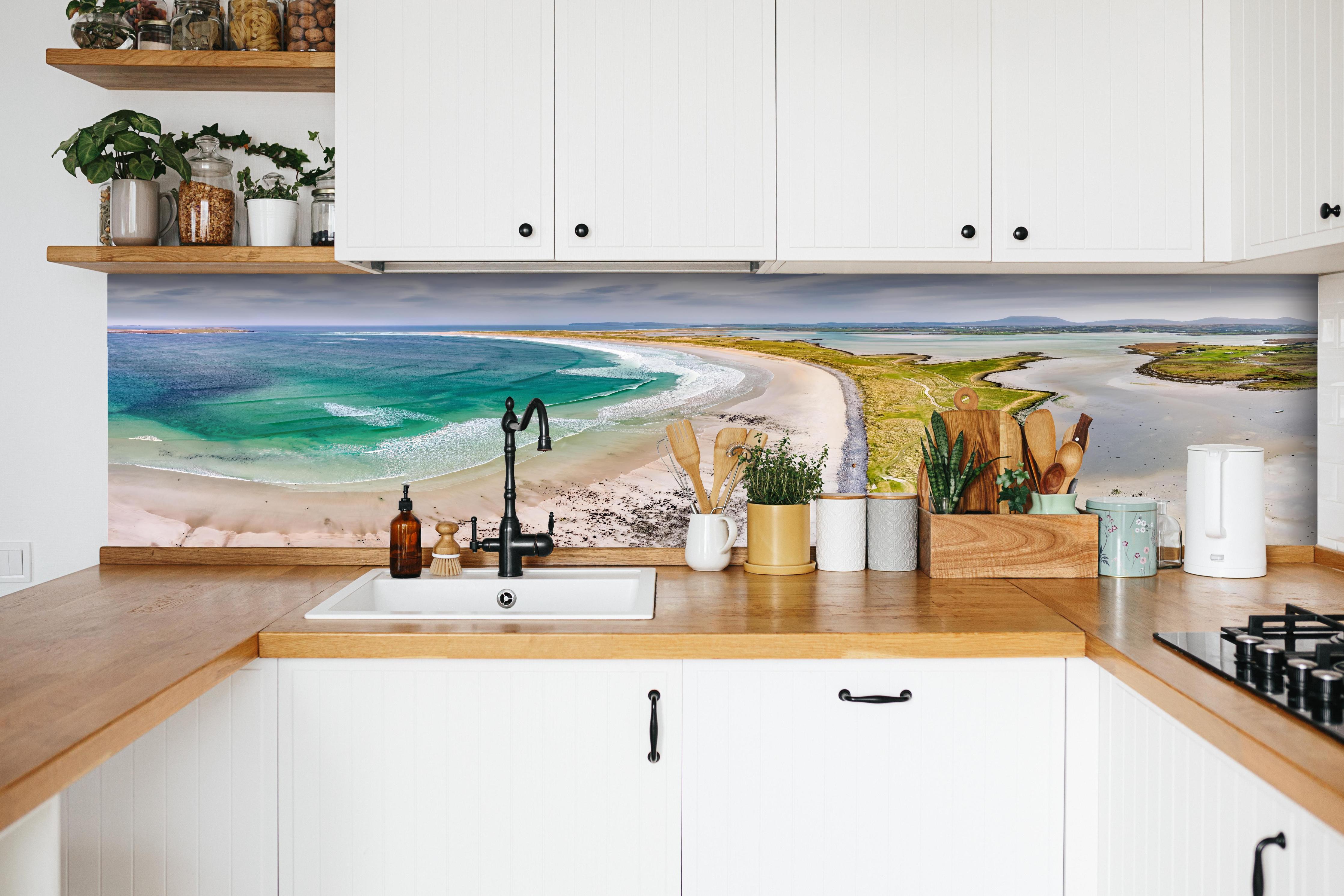 Küche - Luftaufnahme der Küste von Magheraroarty-Irland hinter weißen Hochglanz-Küchenregalen und schwarzem Wasserhahn