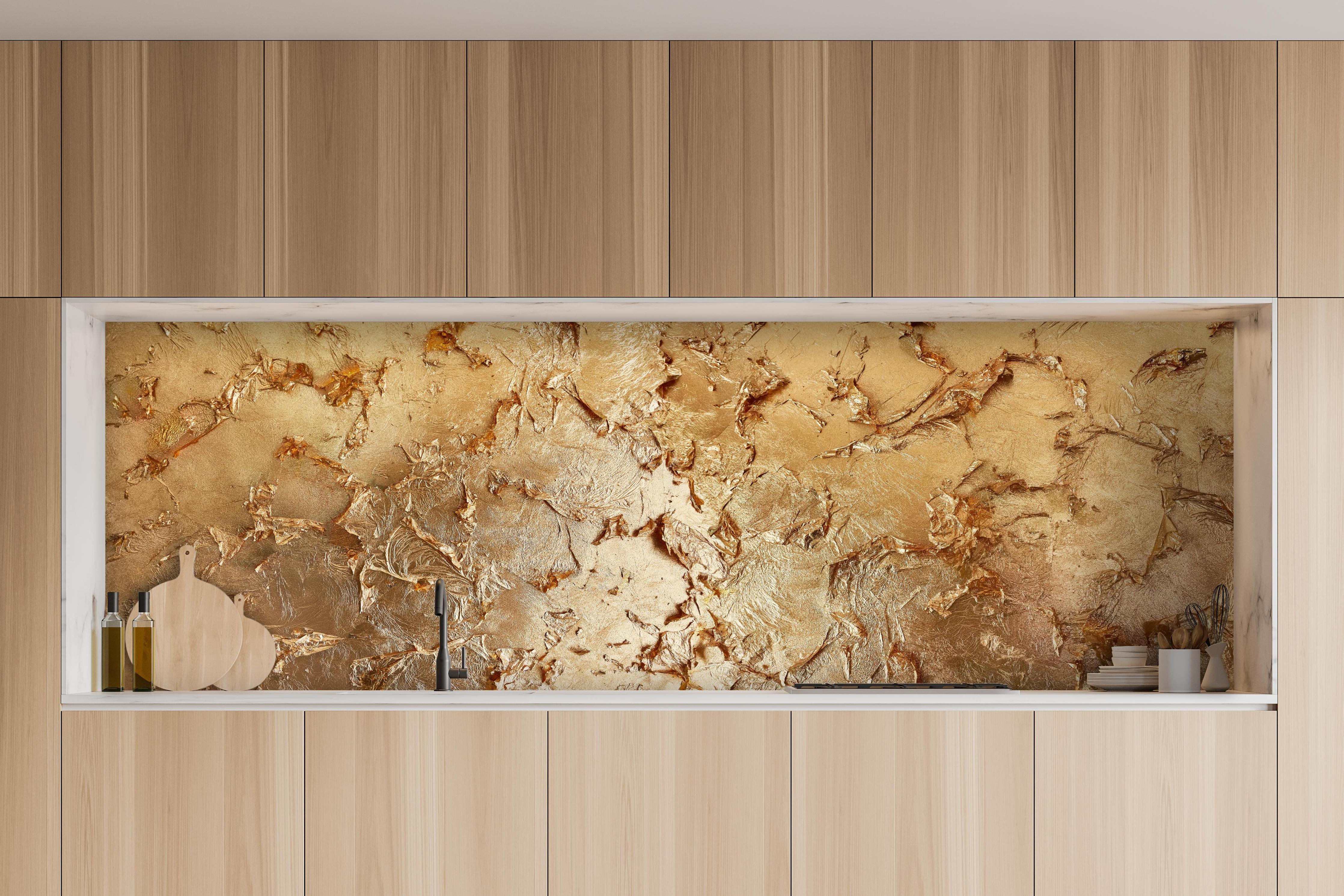 Küche - Muster einer vergoldeten Wand hinter weißen Hochglanz-Küchenregalen und schwarzem Wasserhahn