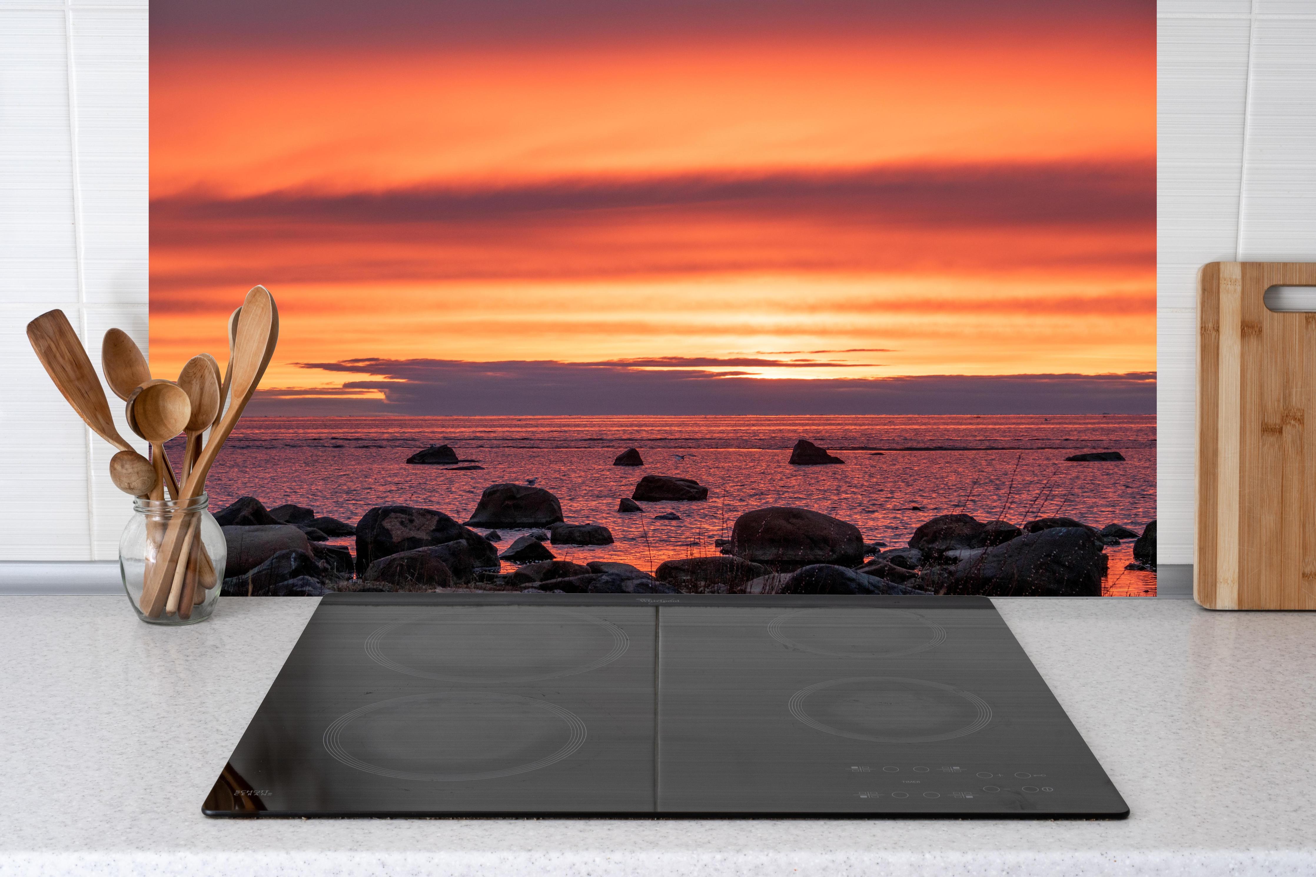 Küche - Schöner Sonnenuntergang am Meer hinter weißen Hochglanz-Küchenregalen und schwarzem Wasserhahn