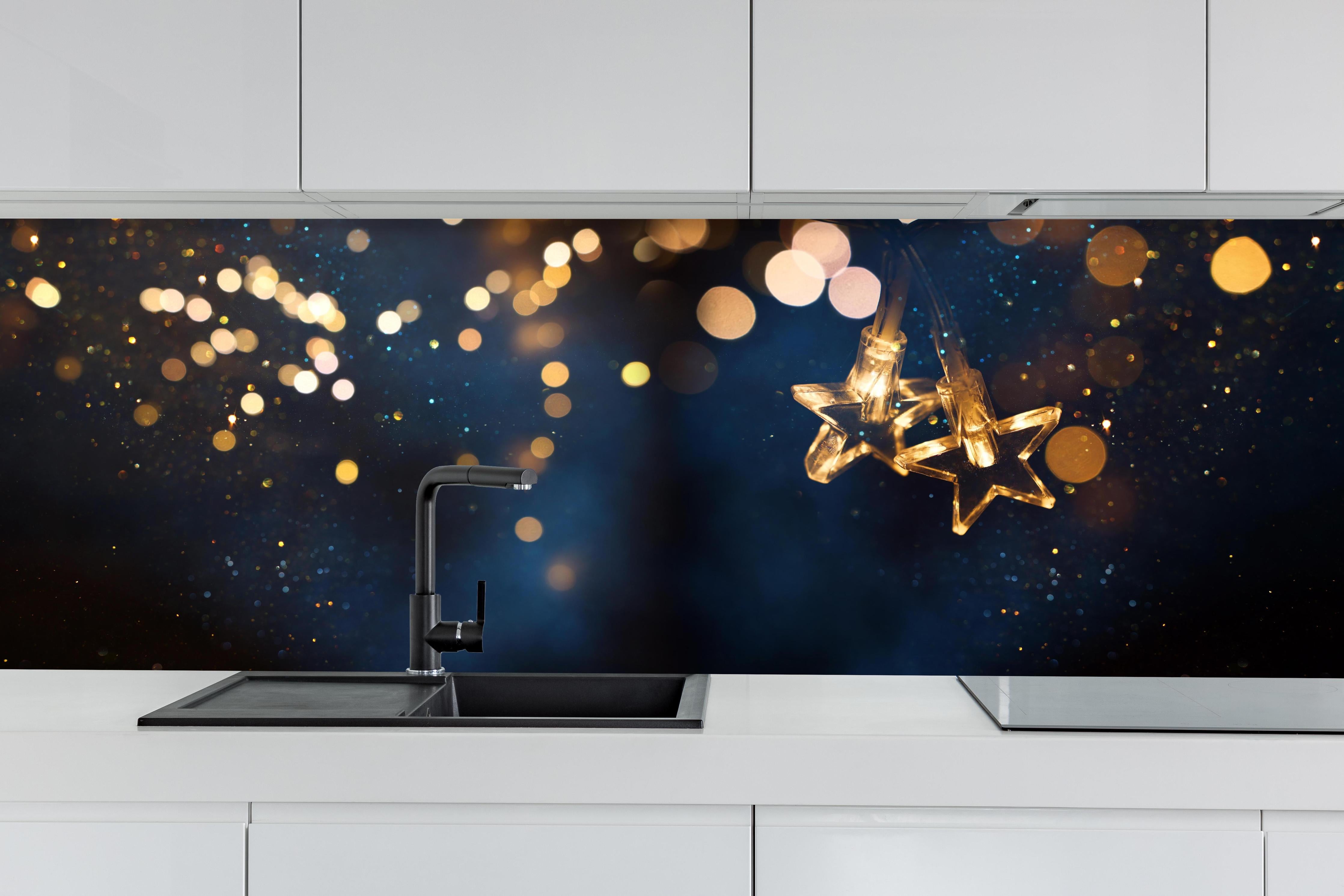 Küche - Winterliche Dekoration - Lichterkette hinter weißen Hochglanz-Küchenregalen und schwarzem Wasserhahn