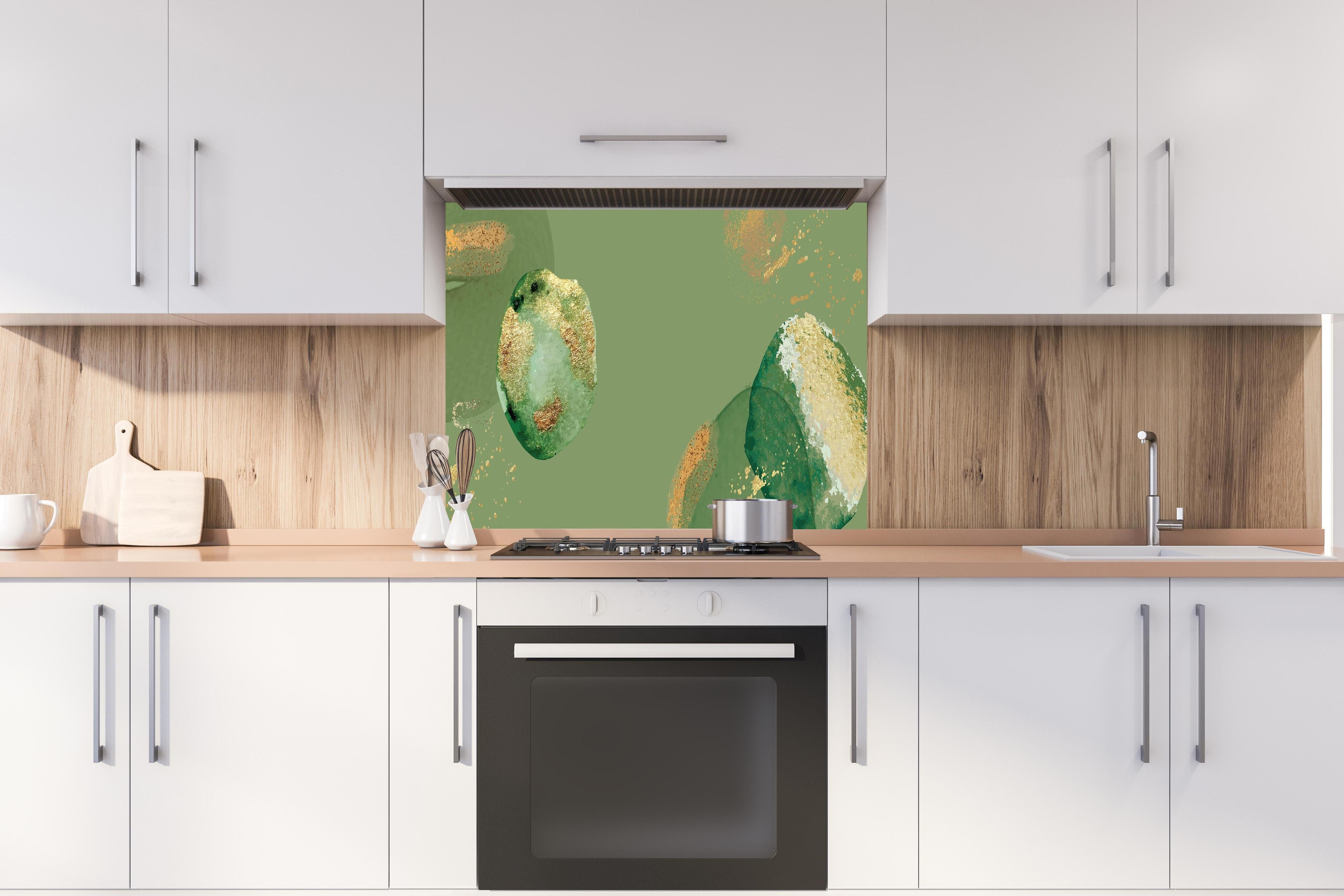 Spritzschutz - Abstrakte Kunst in Grün und Goldtönen hinter einem Cerankochfeld zwischen Holz-Kochutensilien