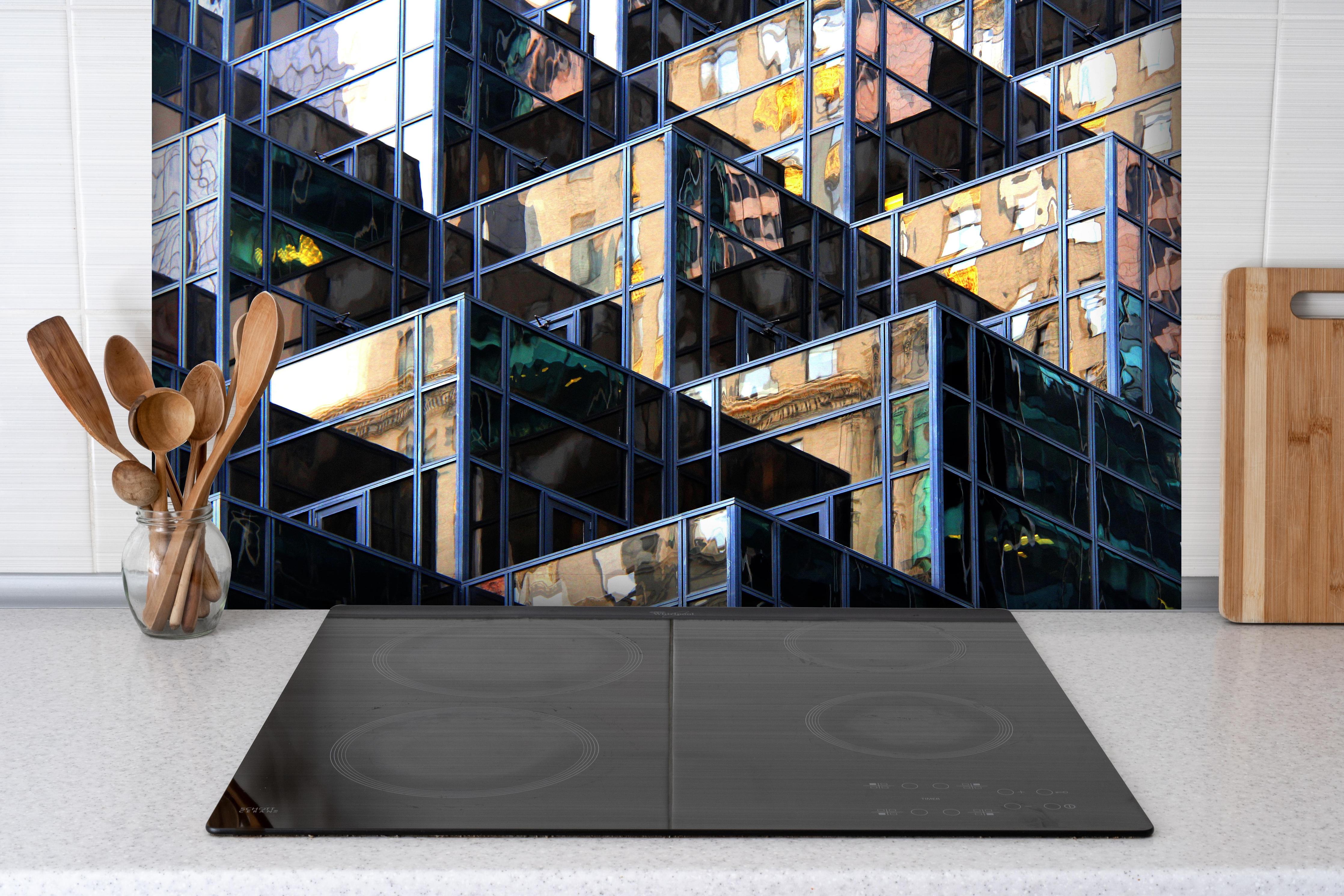 Spritzschutz - Abstrakte Würfel Darstellung hinter einem Cerankochfeld zwischen Holz-Kochutensilien