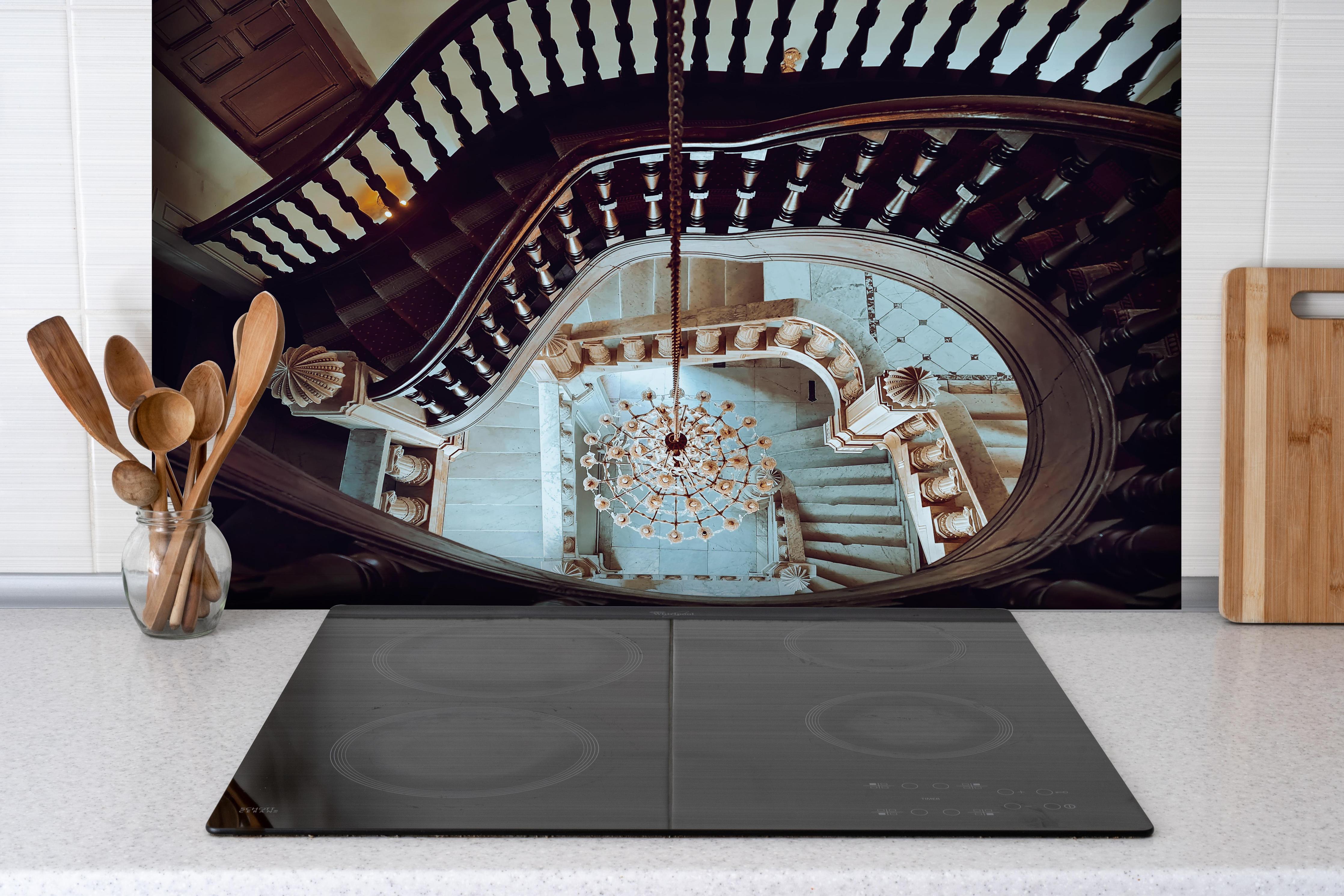 Spritzschutz - Alte Architektur - Baron Empain Palace hinter einem Cerankochfeld zwischen Holz-Kochutensilien