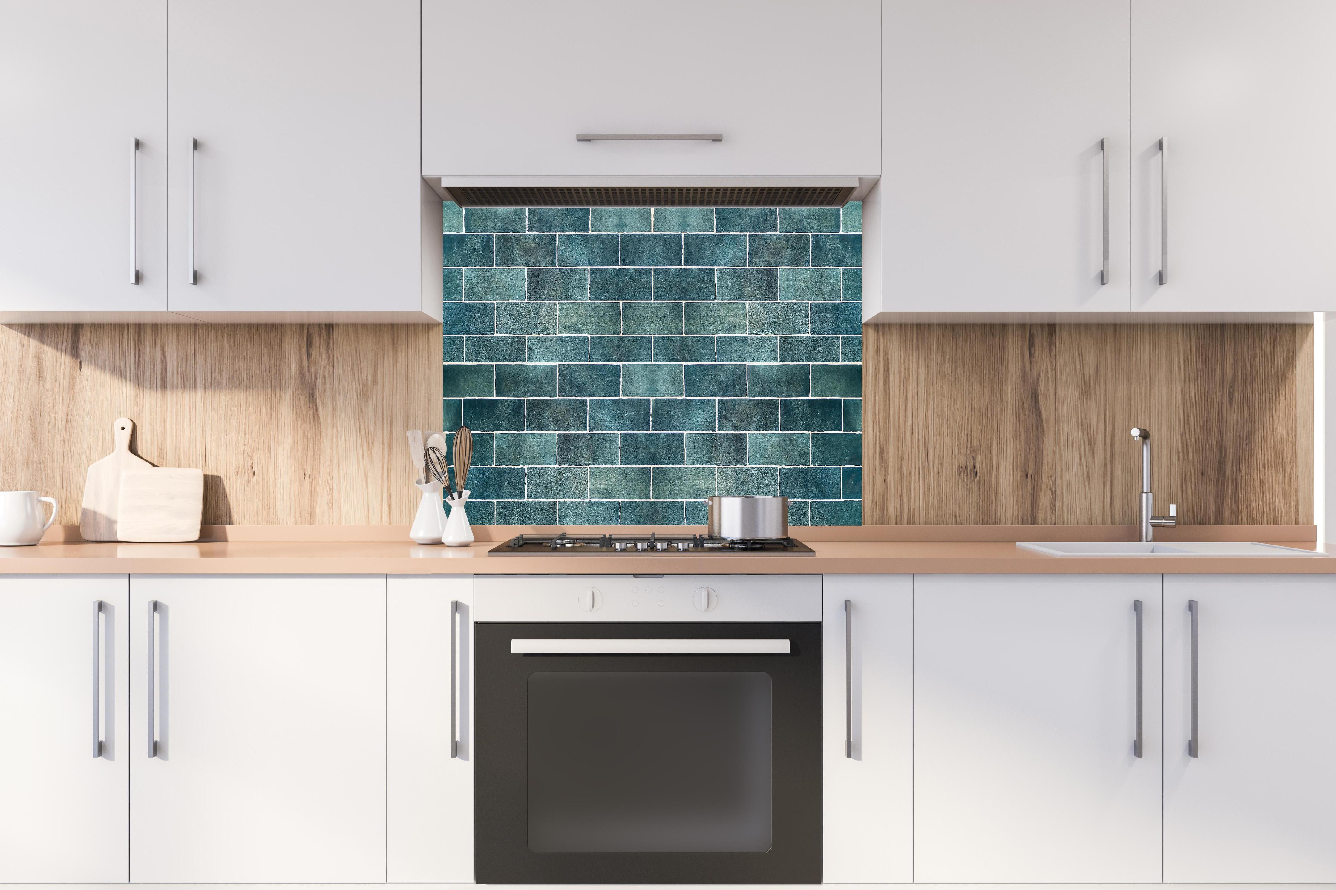 Spritzschutz - Alte Vintage Keramikfliesen in Blau hinter einem Cerankochfeld zwischen Holz-Kochutensilien