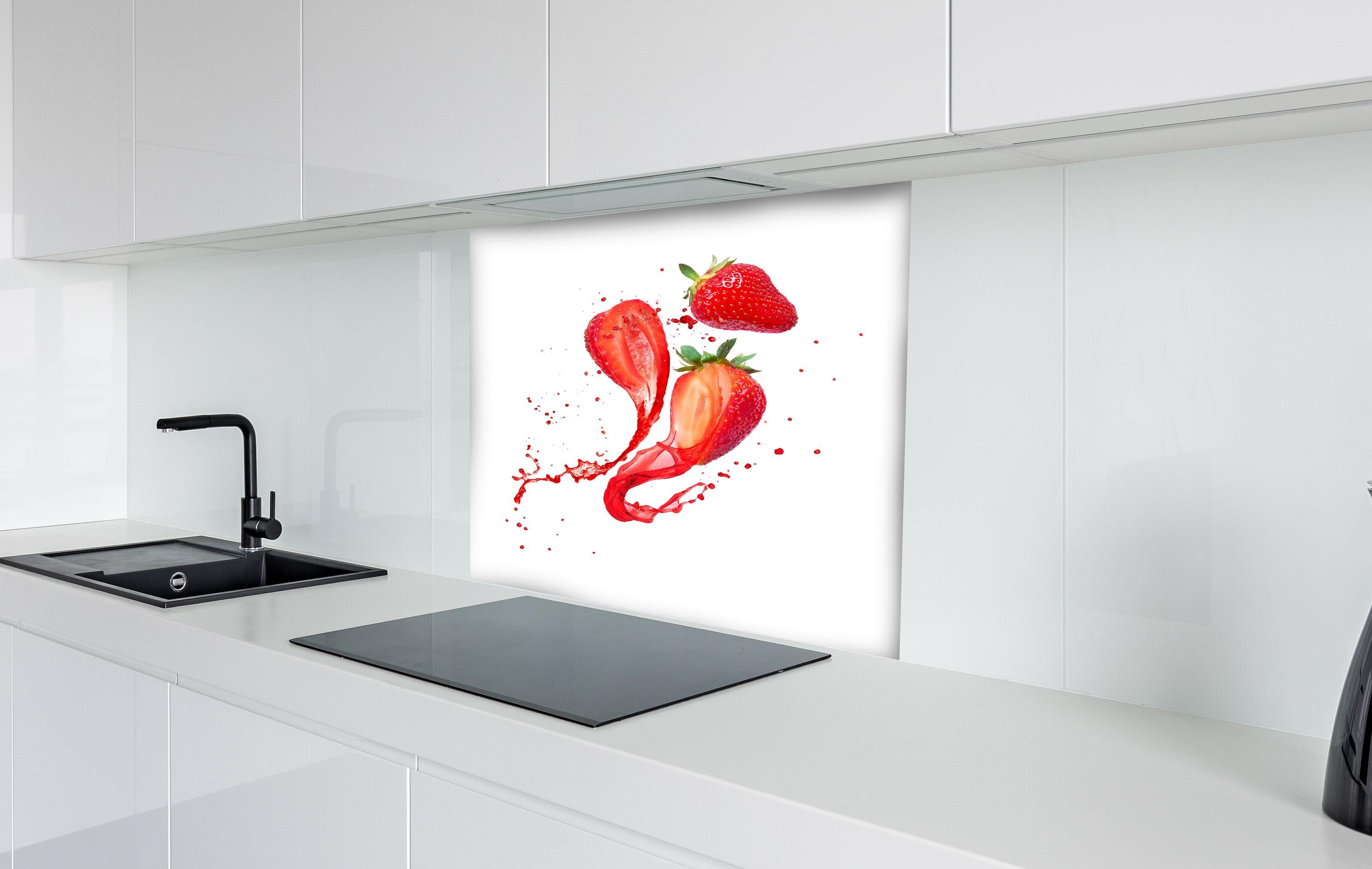 Spritzschutz - Aufgeschnittene Erdbeeren auf weißem Hintergrund hinter einem Cerankochfeld zwischen Holz-Kochutensilien