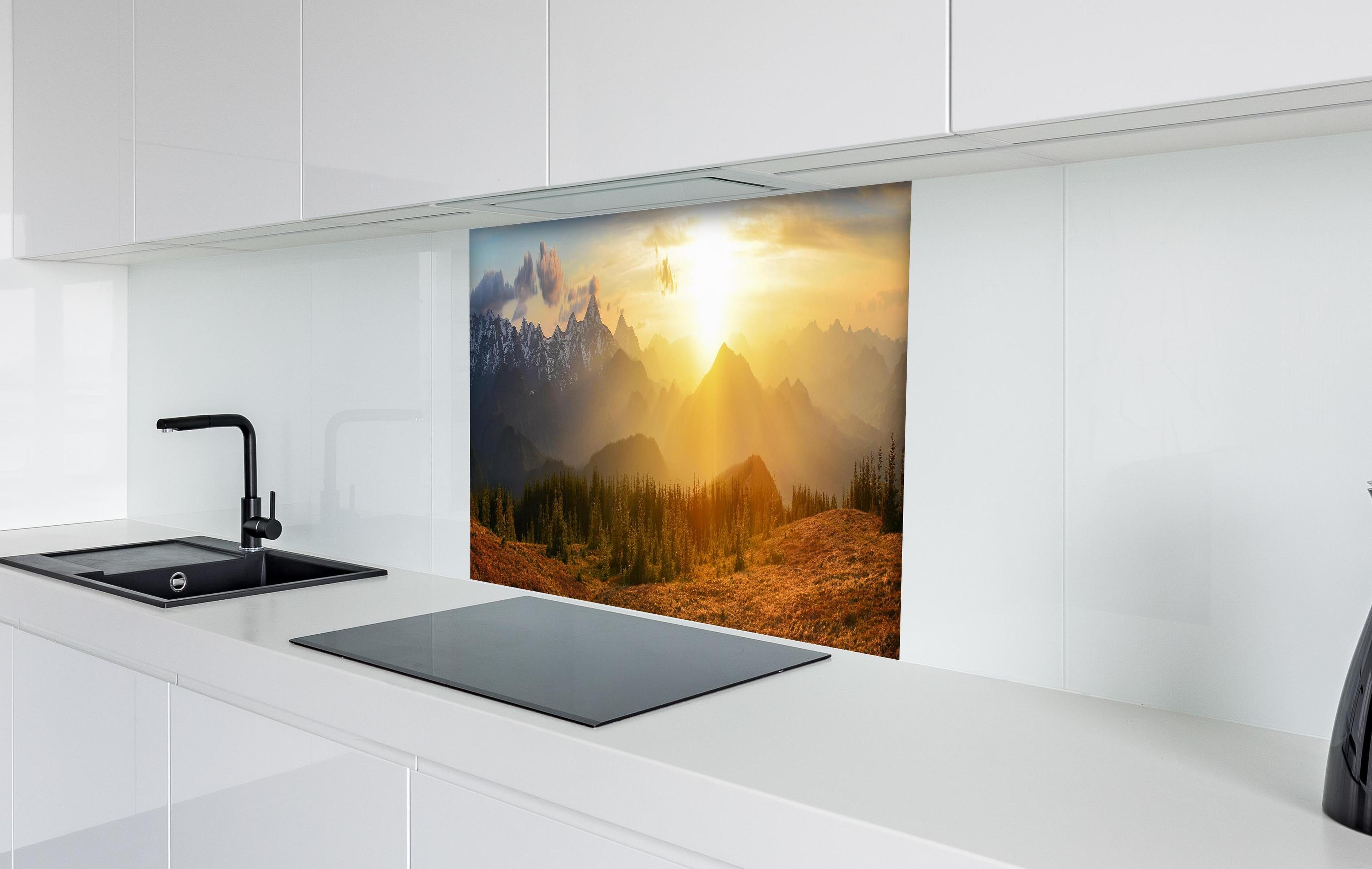 Spritzschutz - Berge im Sonnenuntergang hinter einem Cerankochfeld zwischen Holz-Kochutensilien