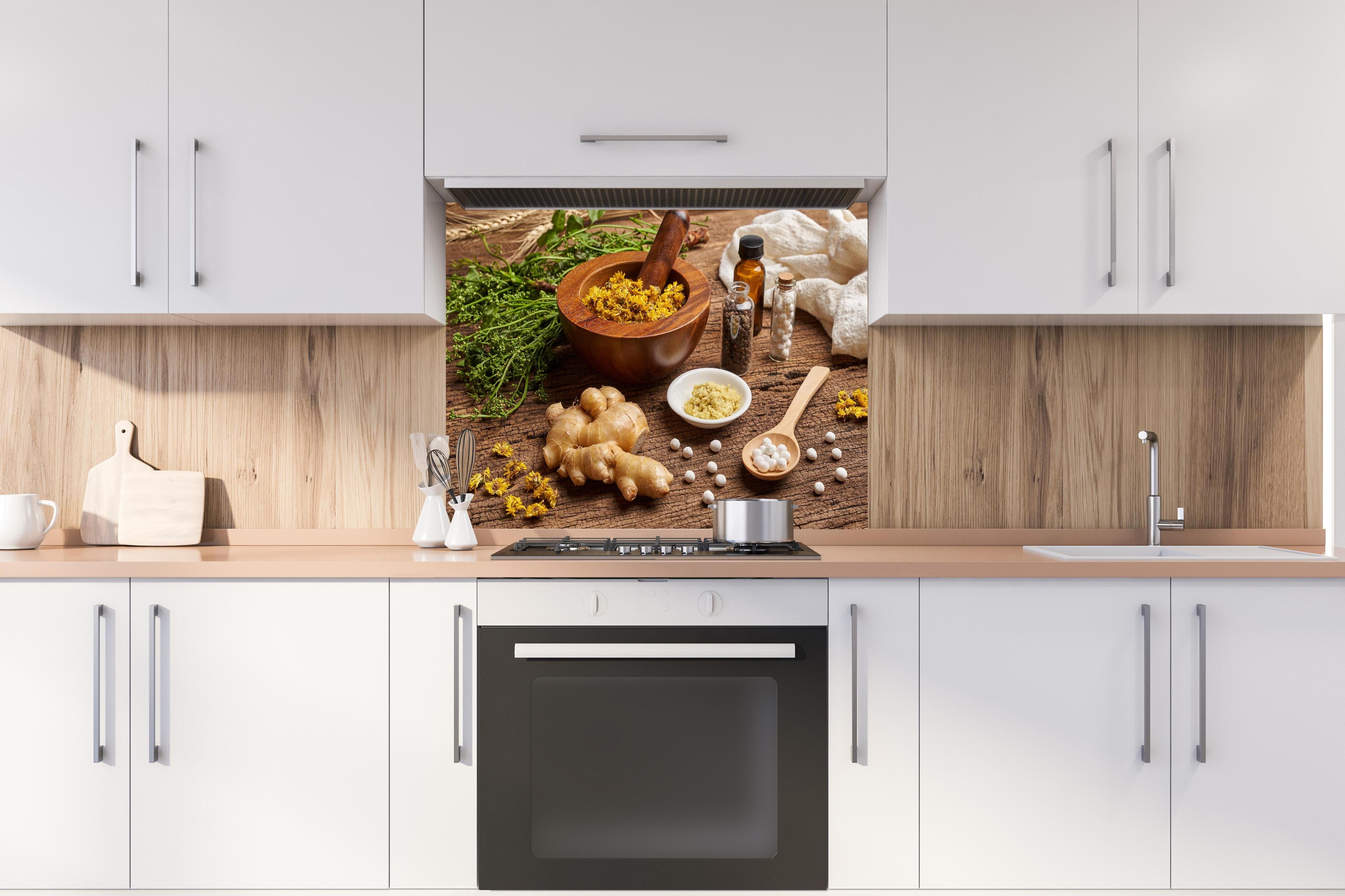 Spritzschutz - Bio Heilkräuter und Naturheilmittel Wellness hinter einem Cerankochfeld zwischen Holz-Kochutensilien