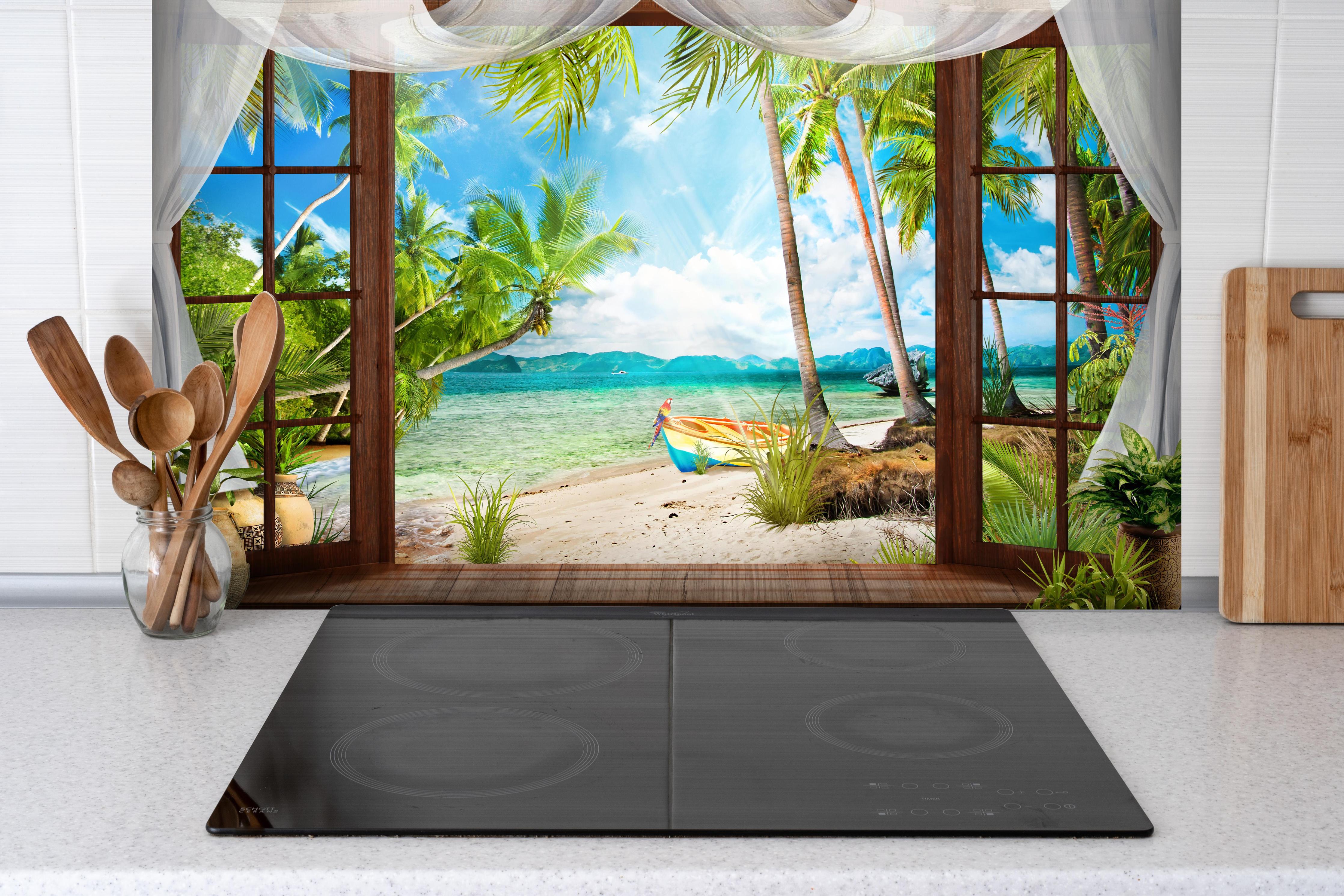 Spritzschutz - Bungalow mit Blick aufs Meer hinter einem Cerankochfeld zwischen Holz-Kochutensilien