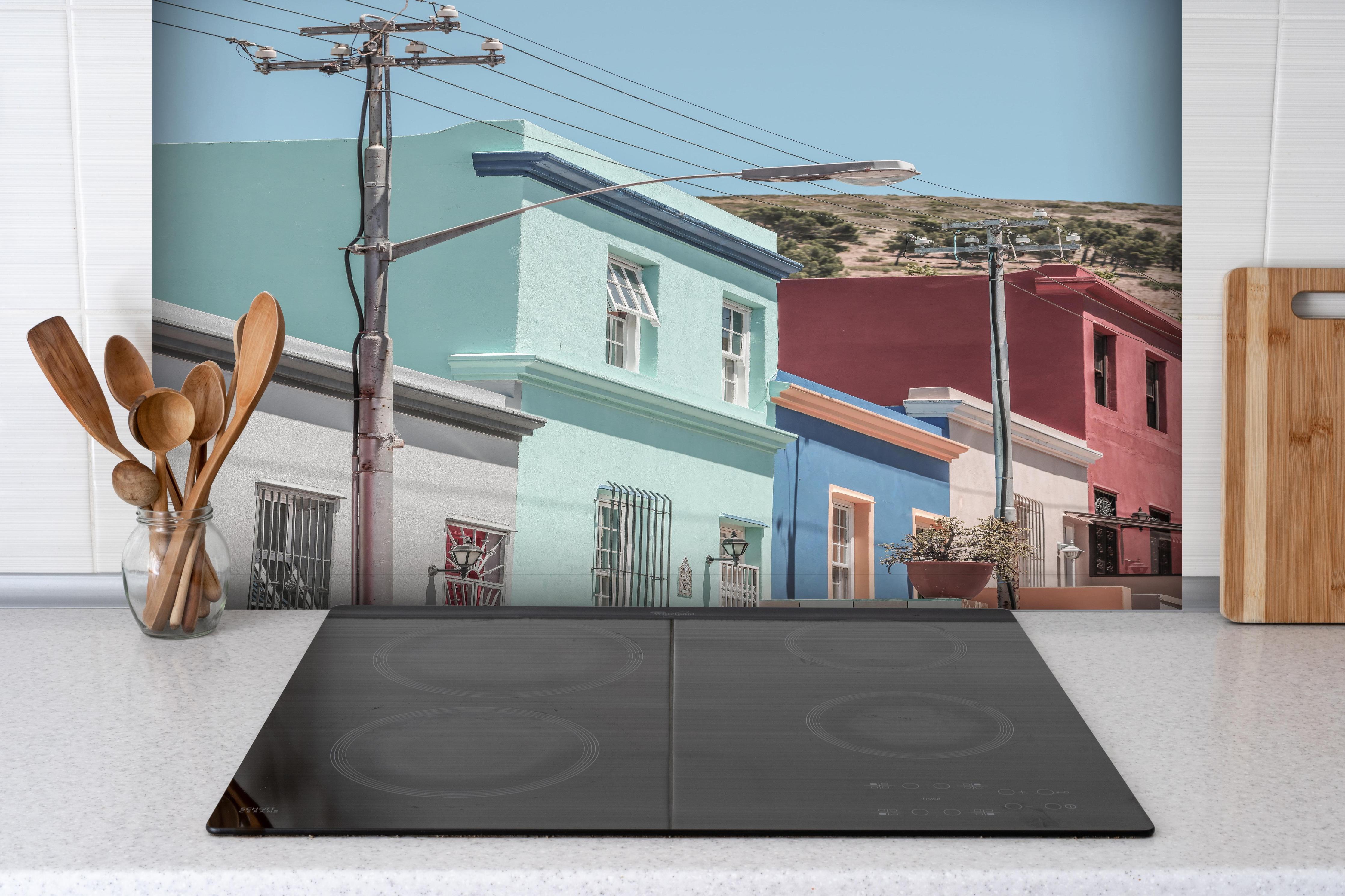 Spritzschutz - Bunte Gebäude - Bo-Kaap, Kapstadt hinter einem Cerankochfeld zwischen Holz-Kochutensilien