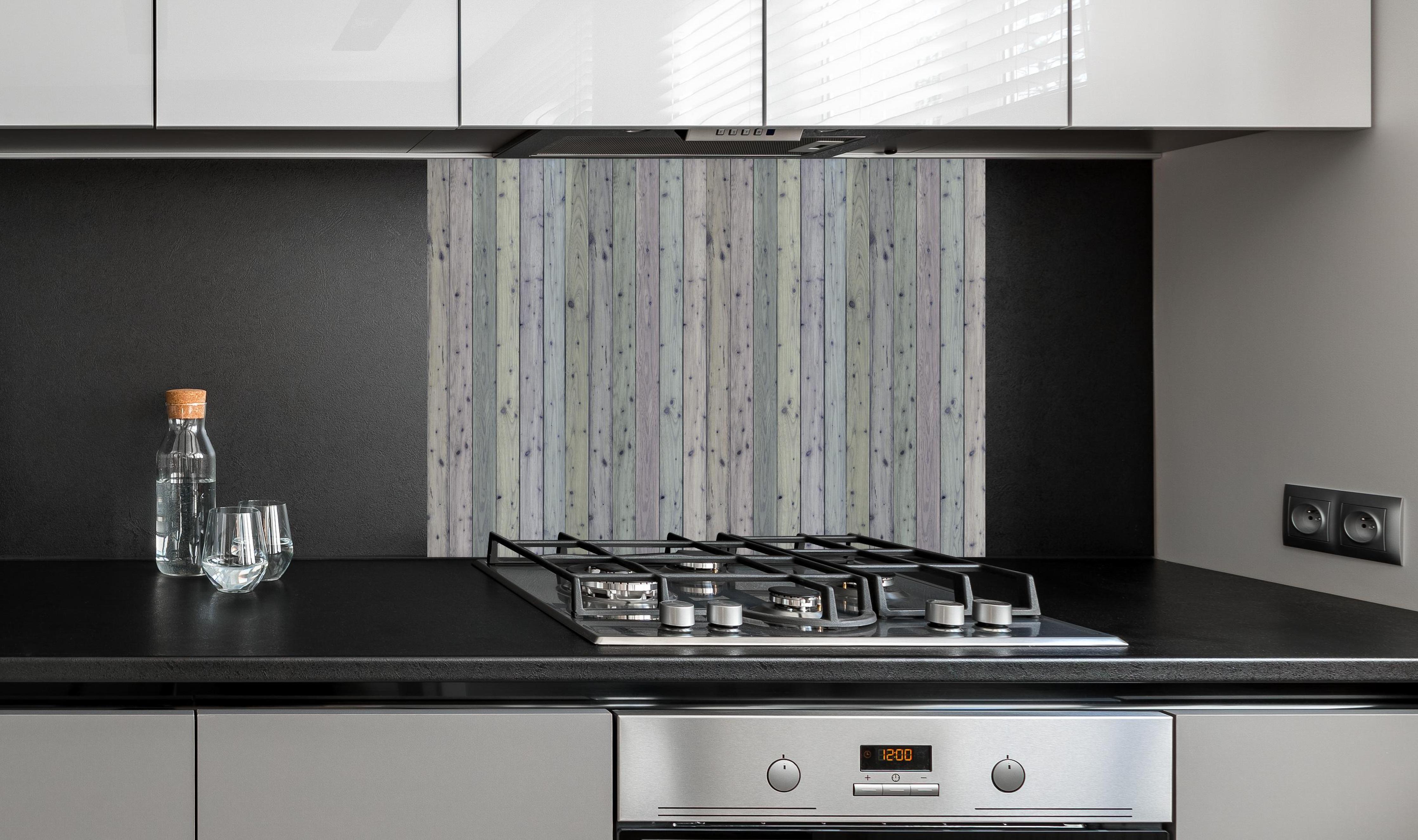 Spritzschutz - Bunte Holz Wand Textur hinter einem Cerankochfeld zwischen Holz-Kochutensilien