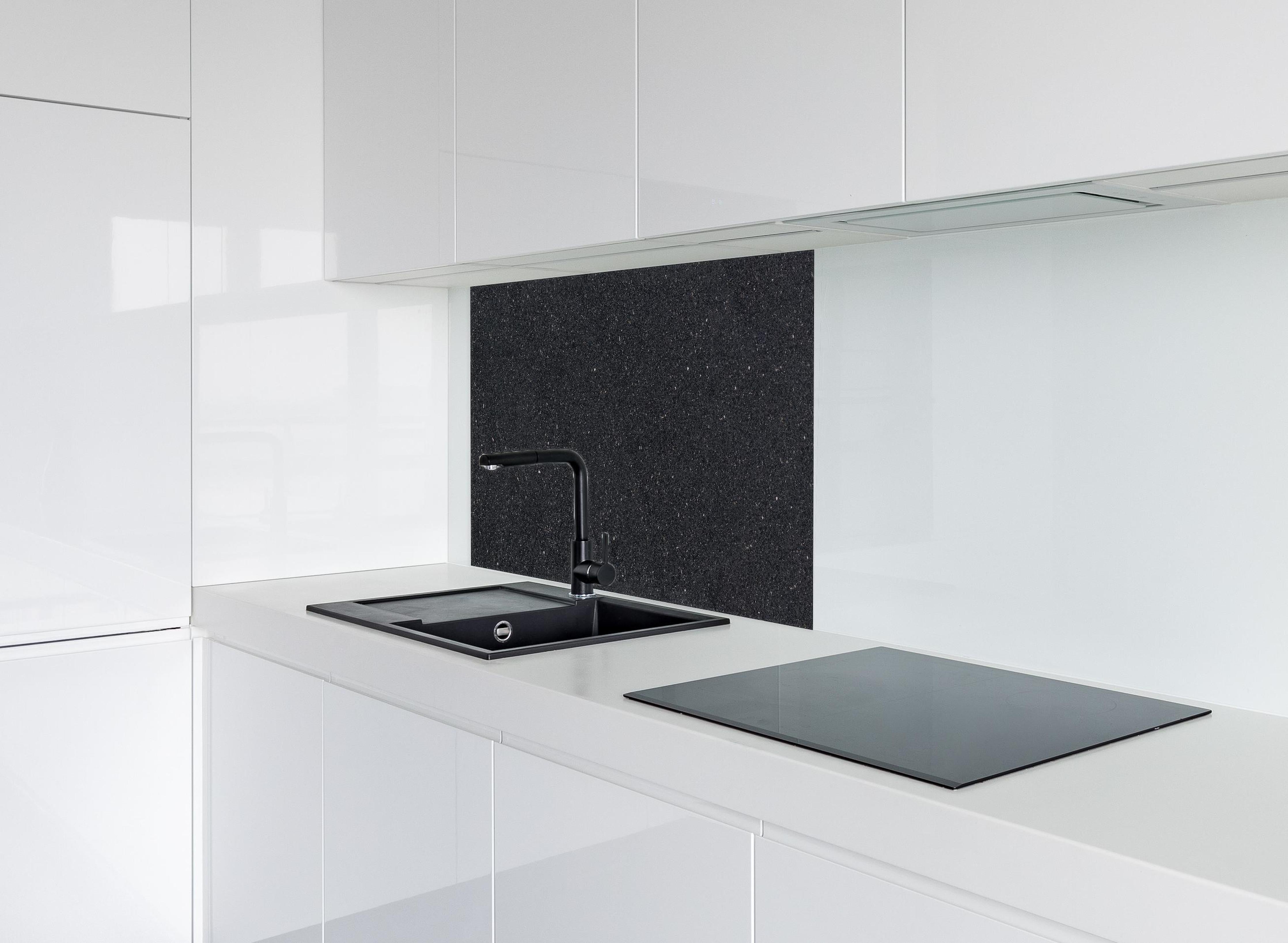 Spritzschutz - Edle schwarze Granite Marmor-Textur hinter einem Cerankochfeld zwischen Holz-Kochutensilien