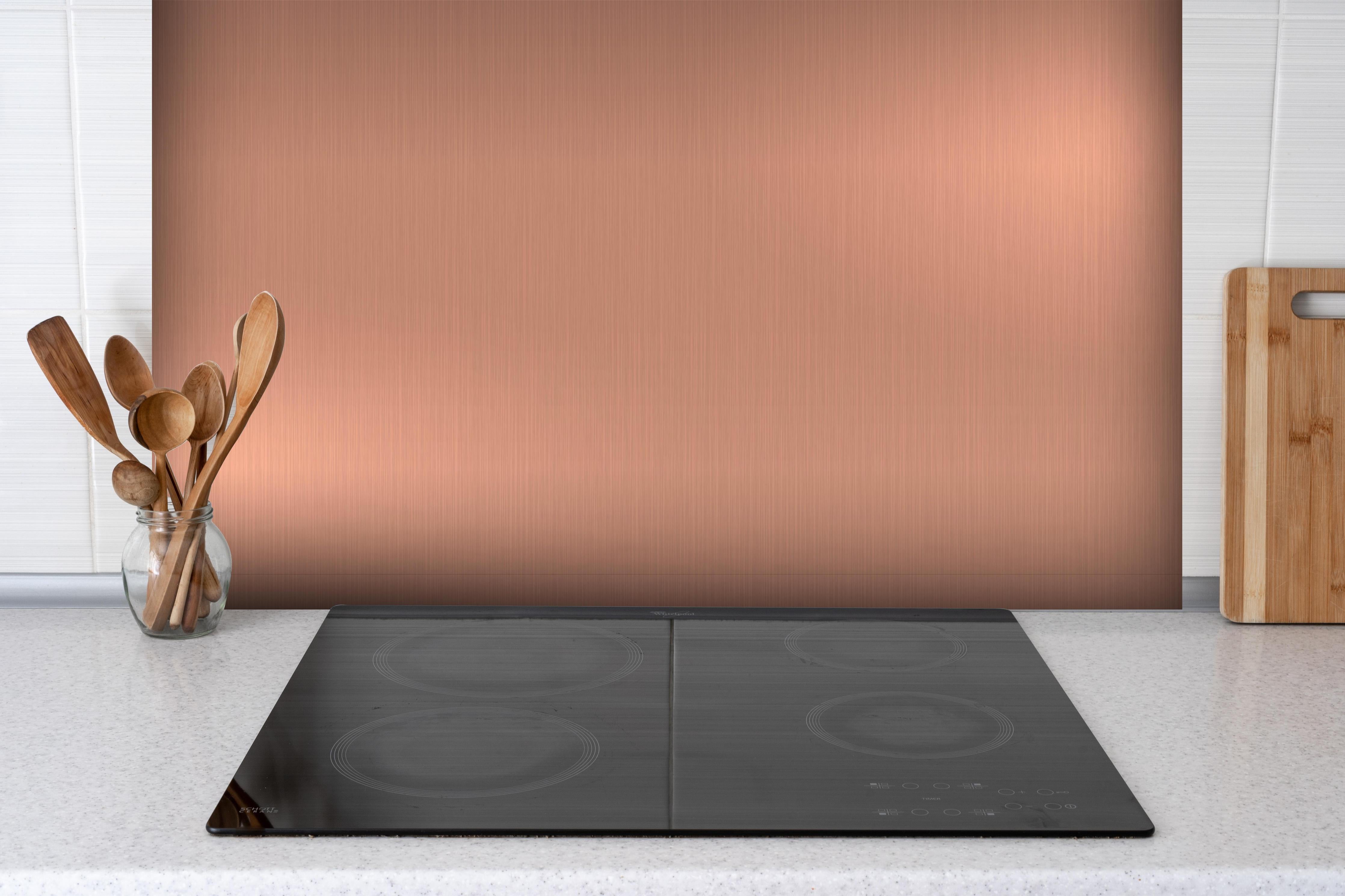 Spritzschutz - Elegante Gebürstete Metall Bronzefarben Struktur hinter einem Cerankochfeld zwischen Holz-Kochutensilien