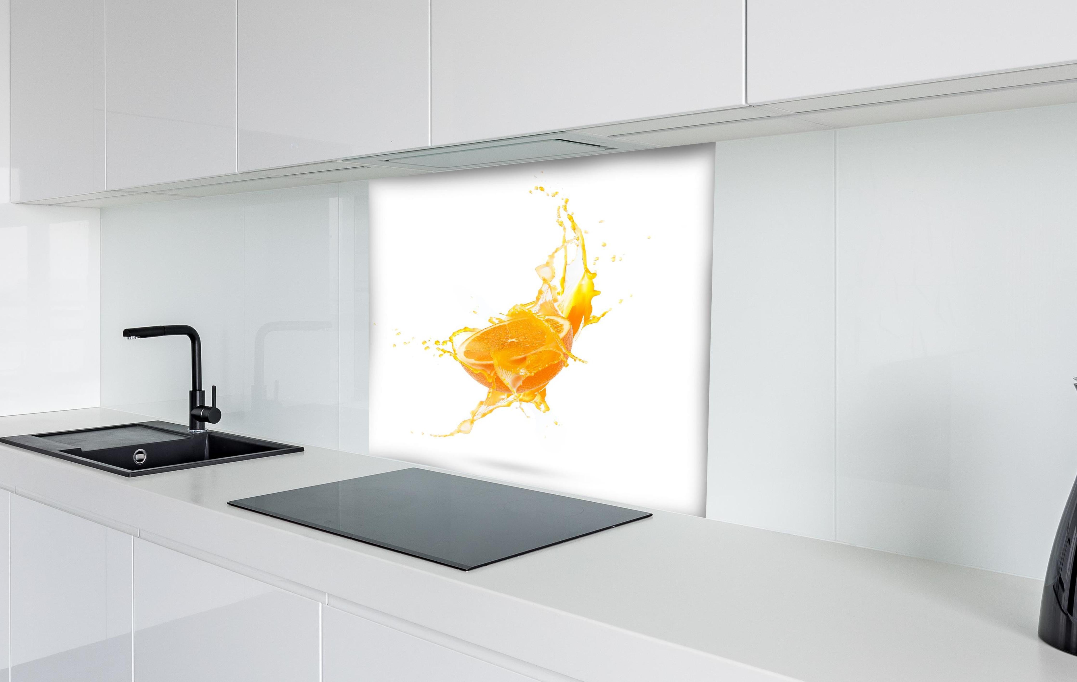 Spritzschutz - Frische Orangen-Hälfte mit Spritzwasser hinter einem Cerankochfeld zwischen Holz-Kochutensilien