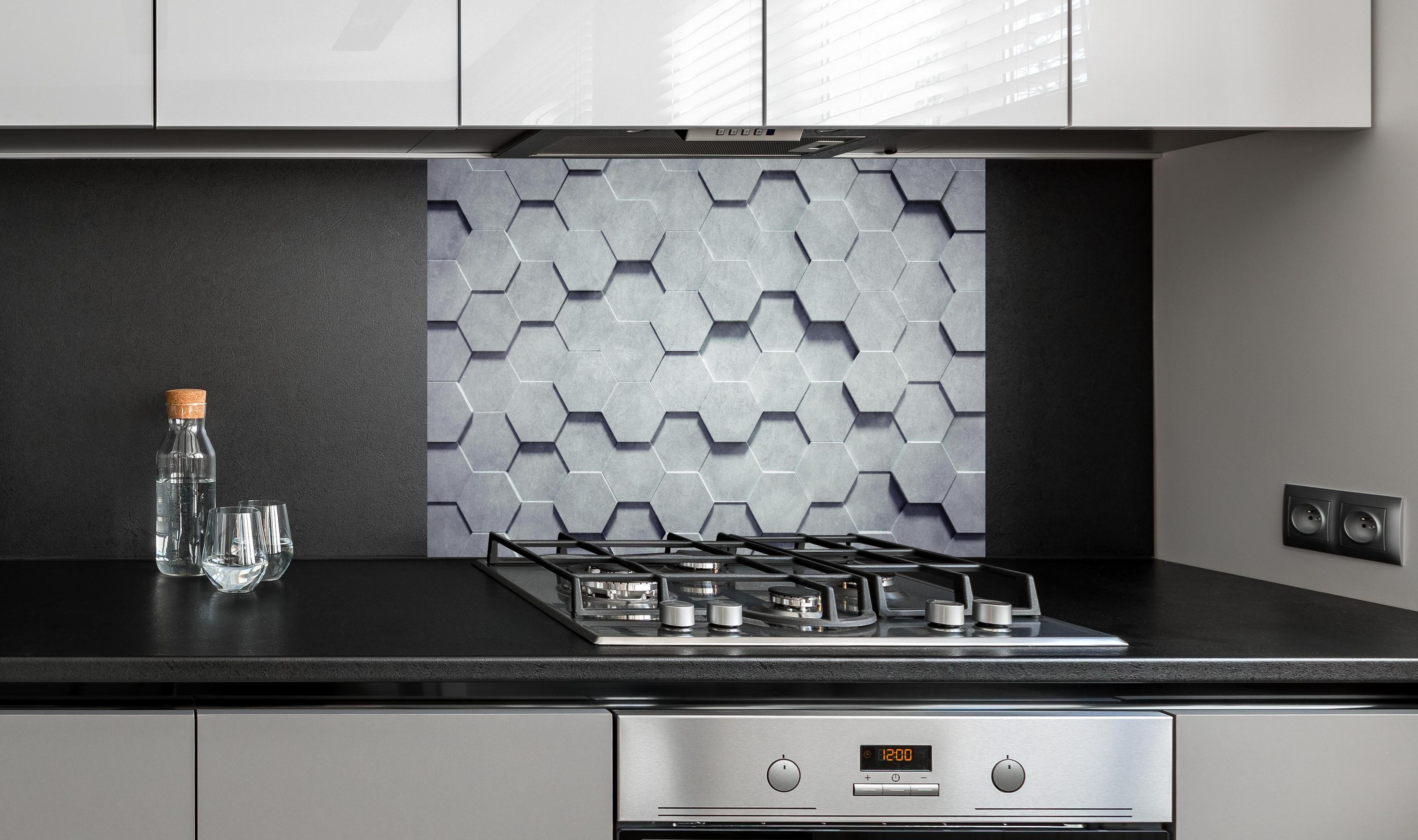 Spritzschutz - Gräuliches Wabenmuster hinter einem Cerankochfeld zwischen Holz-Kochutensilien