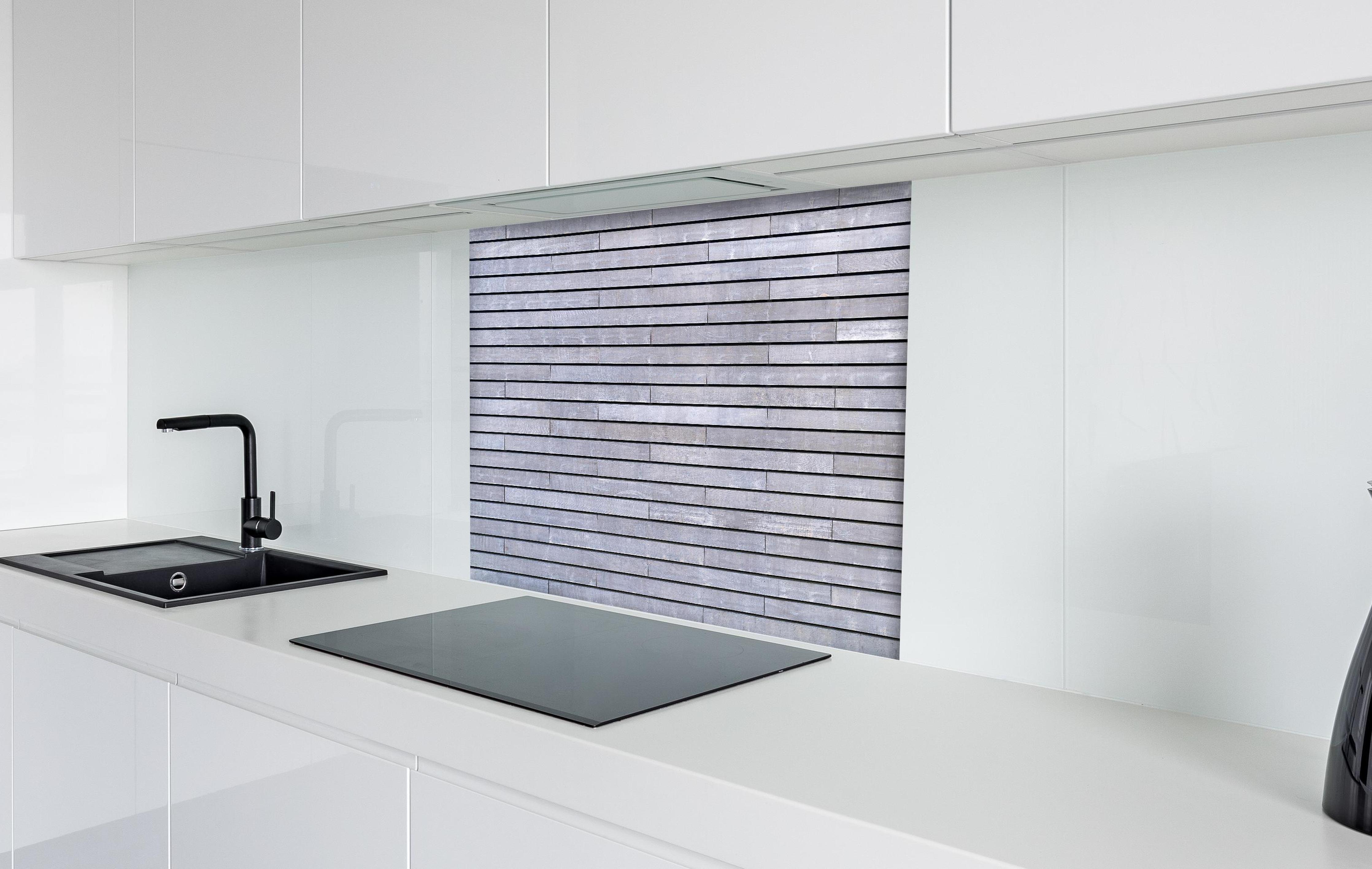 Spritzschutz - Graue Holzverkleidung hinter einem Cerankochfeld zwischen Holz-Kochutensilien