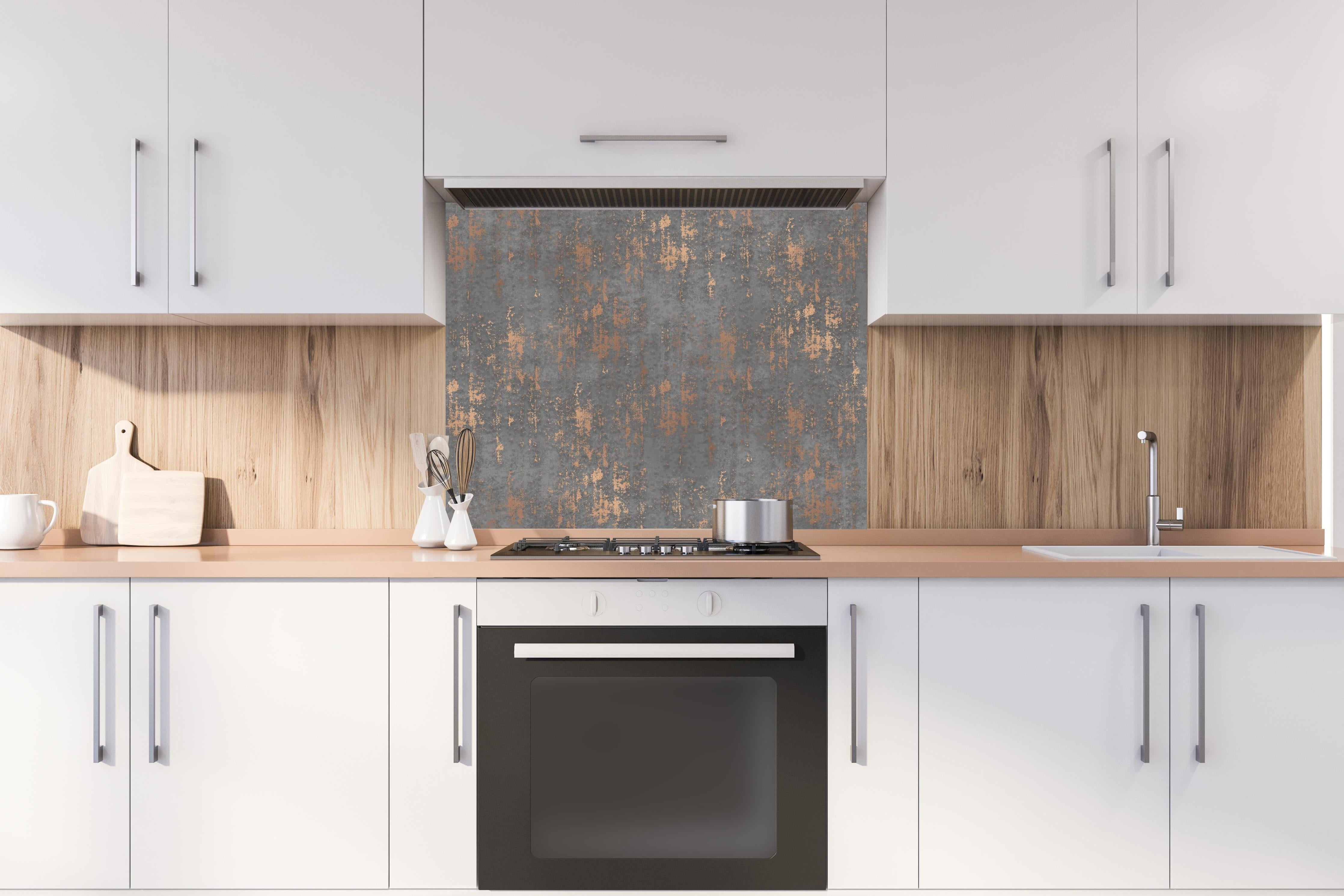 Spritzschutz - Graue Textur mit goldenen Akzenten hinter einem Cerankochfeld zwischen Holz-Kochutensilien