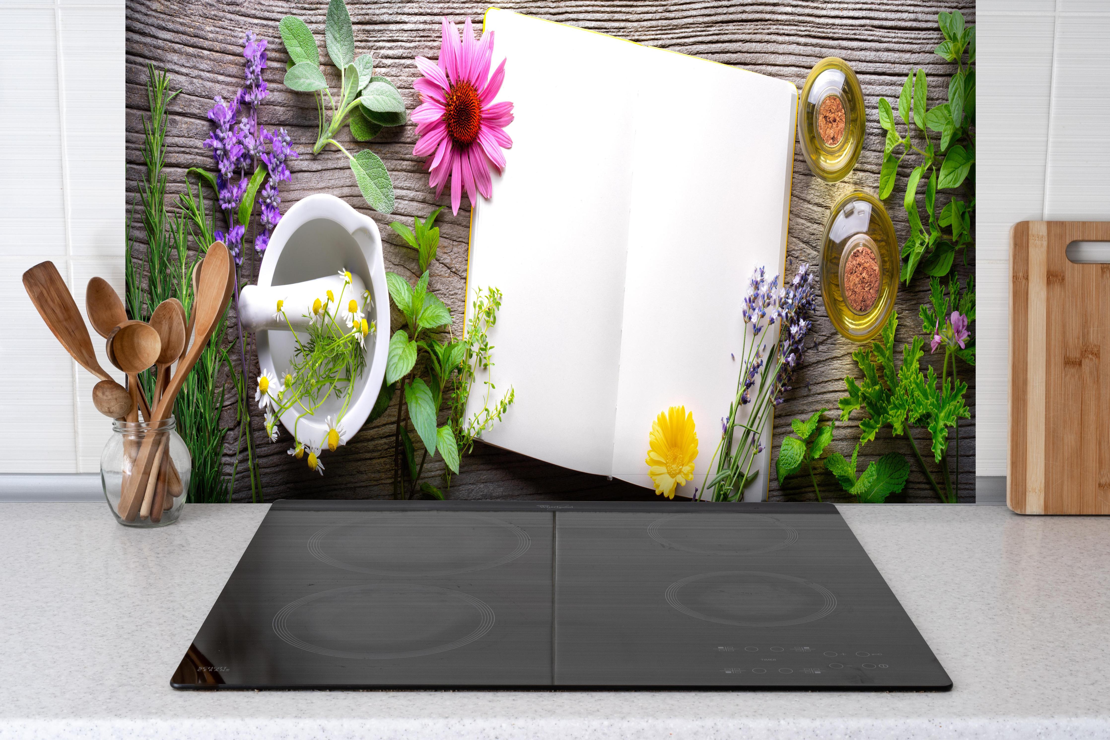 Spritzschutz - Kräuter & Blumen hinter einem Cerankochfeld zwischen Holz-Kochutensilien