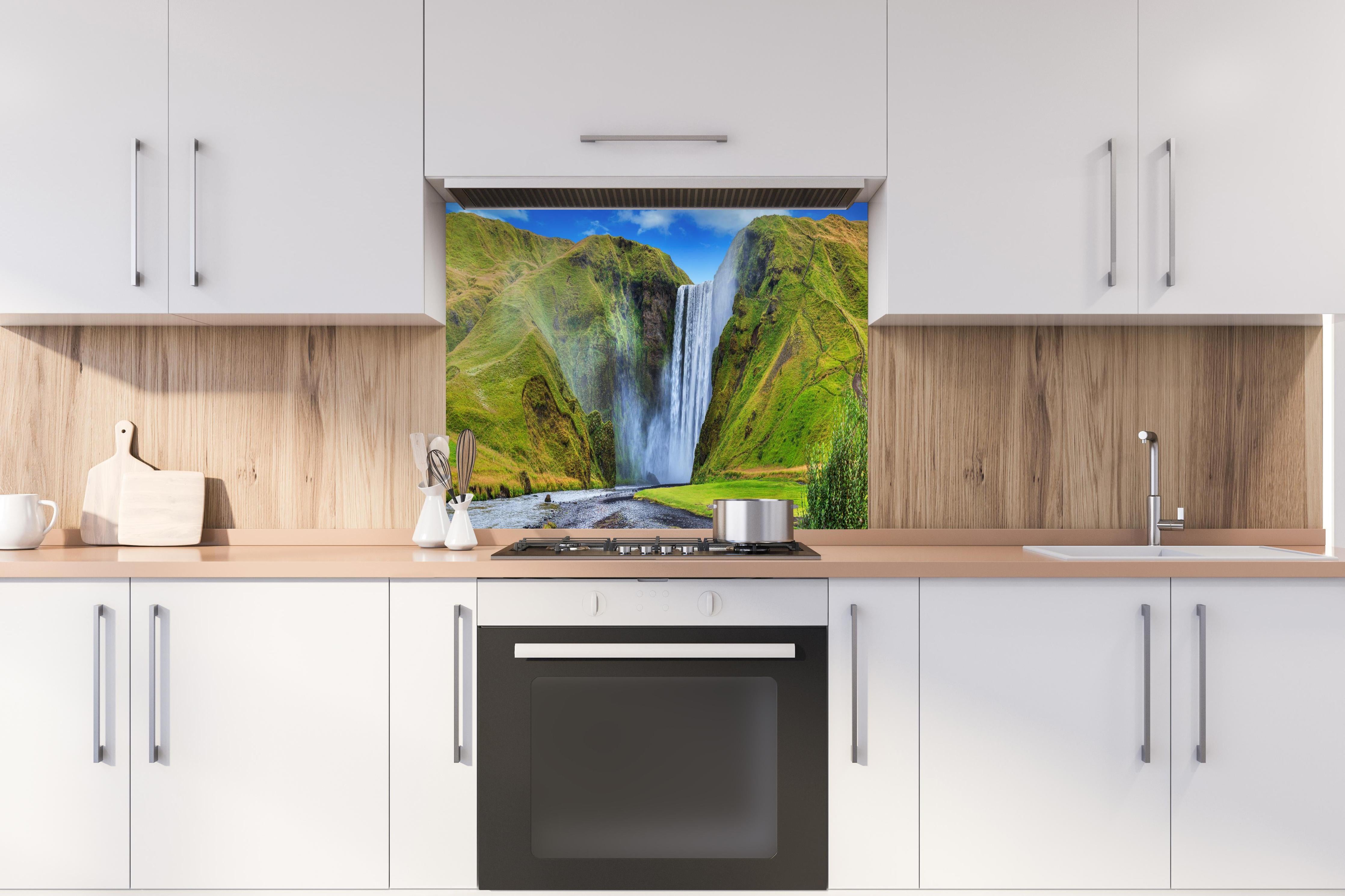 Spritzschutz - Kraftvoller Wasserfall hinter einem Cerankochfeld zwischen Holz-Kochutensilien