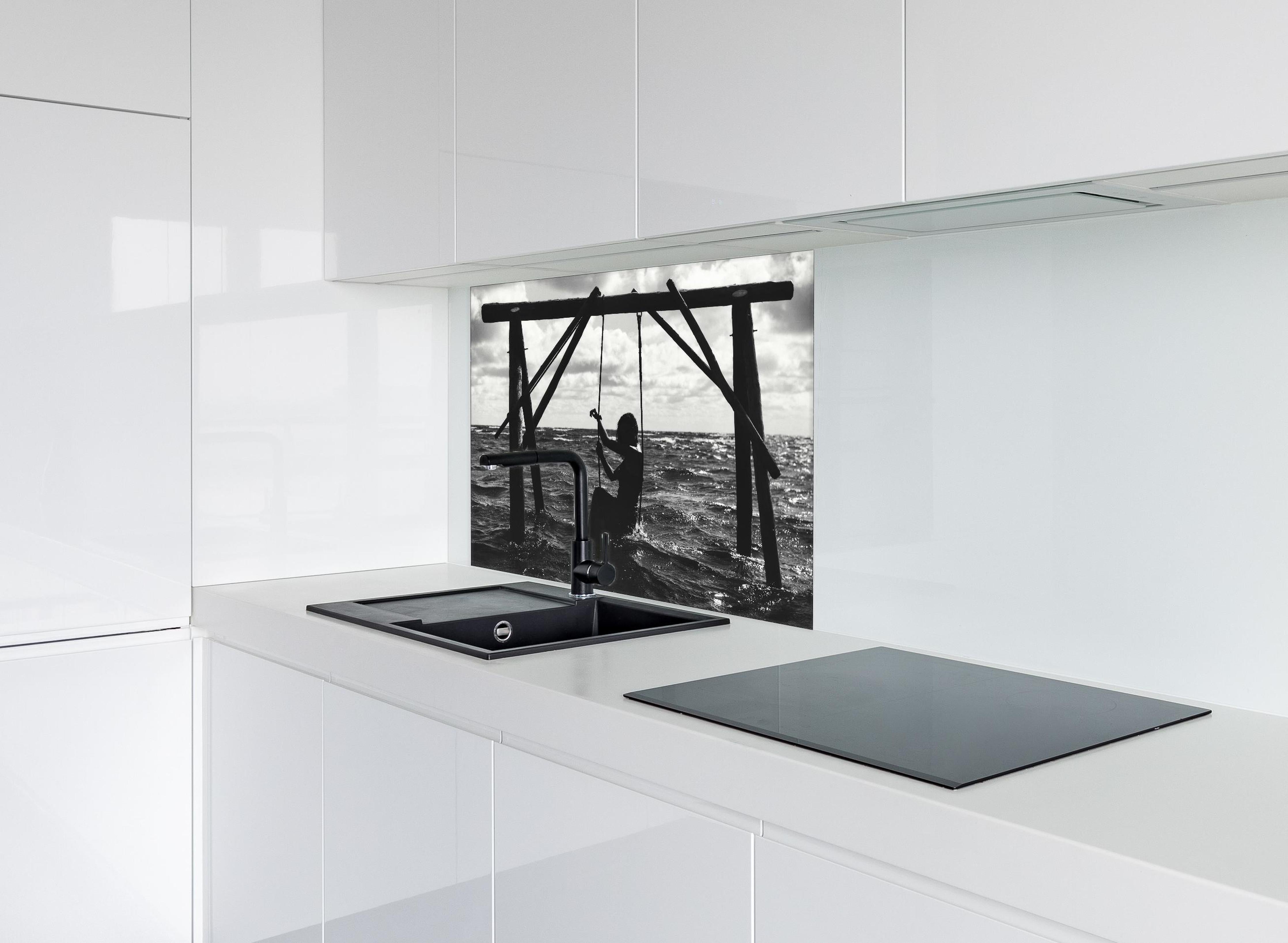 Spritzschutz - Mädchen auf Schaukel im Wasser hinter einem Cerankochfeld zwischen Holz-Kochutensilien