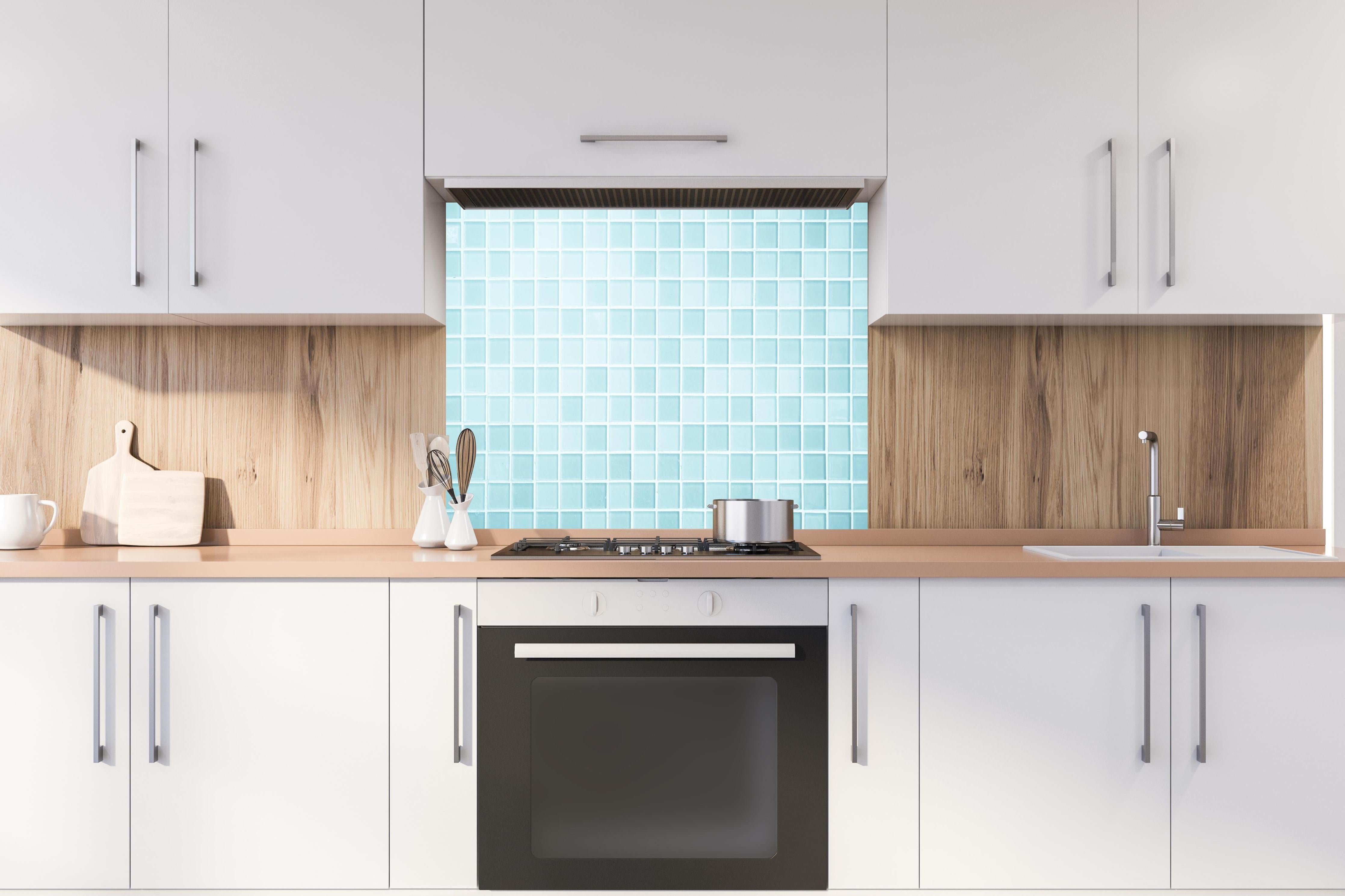 Spritzschutz - Moderne Blau-Weiße Wand- und Bodenfliesen hinter einem Cerankochfeld zwischen Holz-Kochutensilien