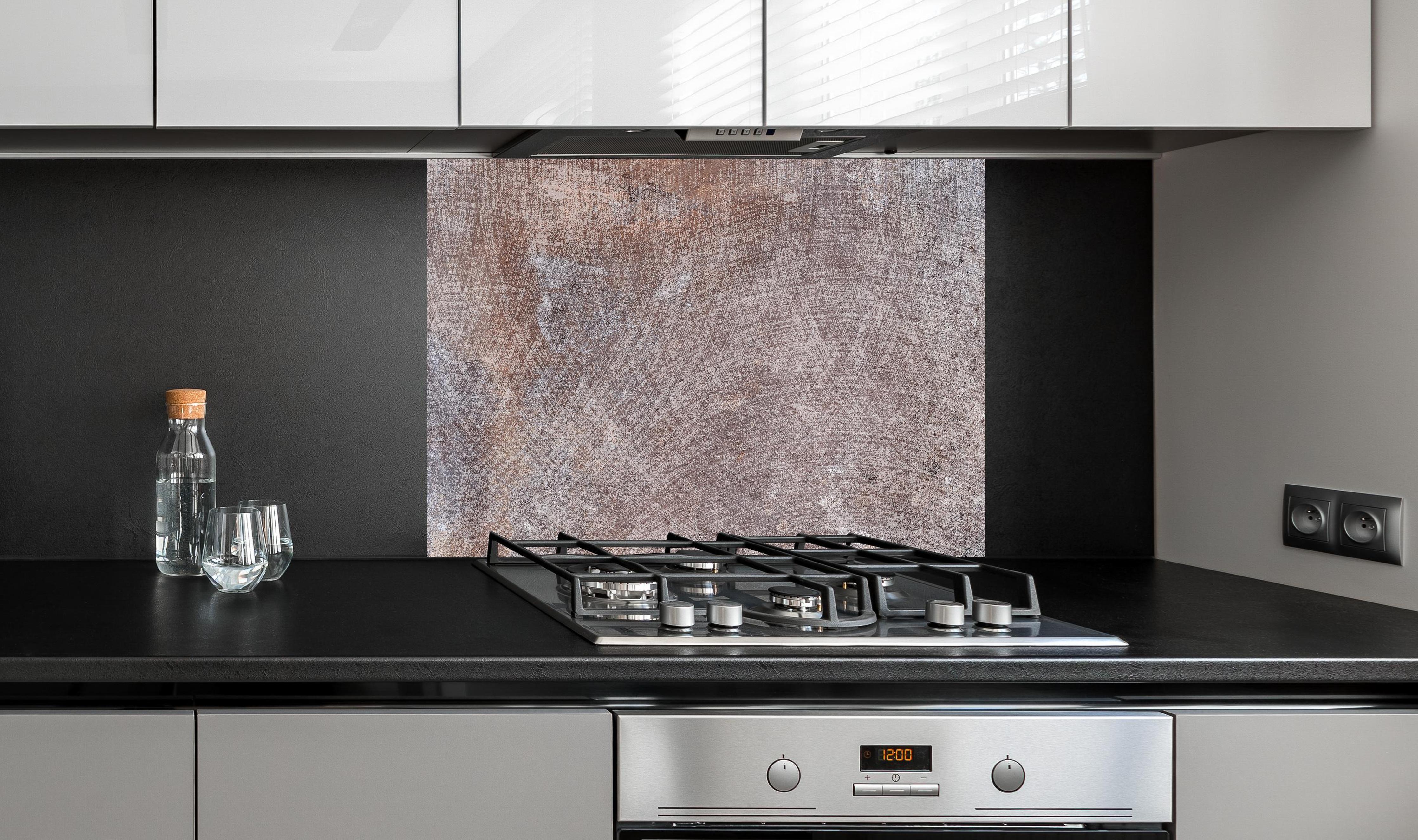 Spritzschutz - Moderne graue Marmor Betontextur hinter einem Cerankochfeld zwischen Holz-Kochutensilien