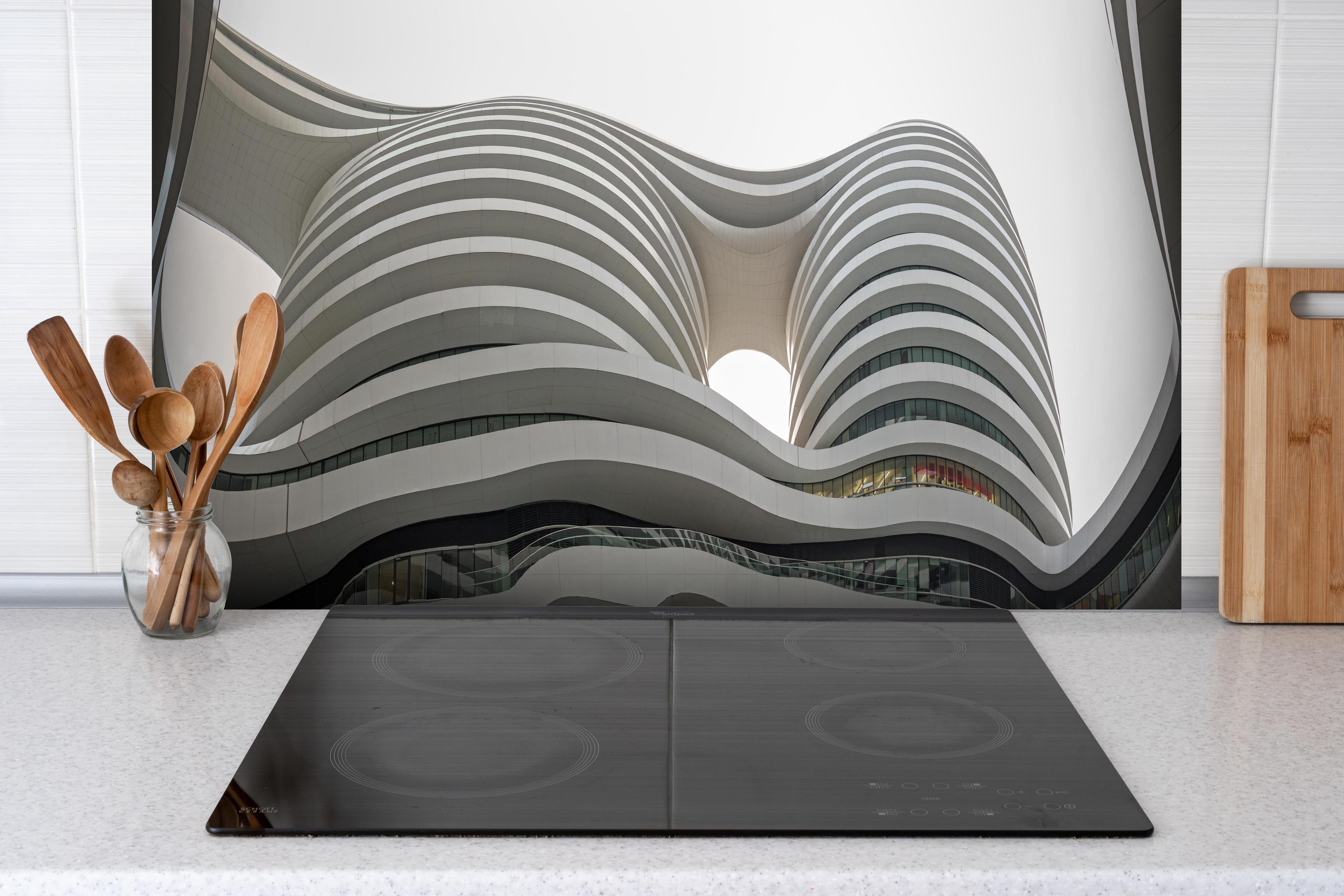 Spritzschutz - Modernes Gebäude Moon Gate in China hinter einem Cerankochfeld zwischen Holz-Kochutensilien