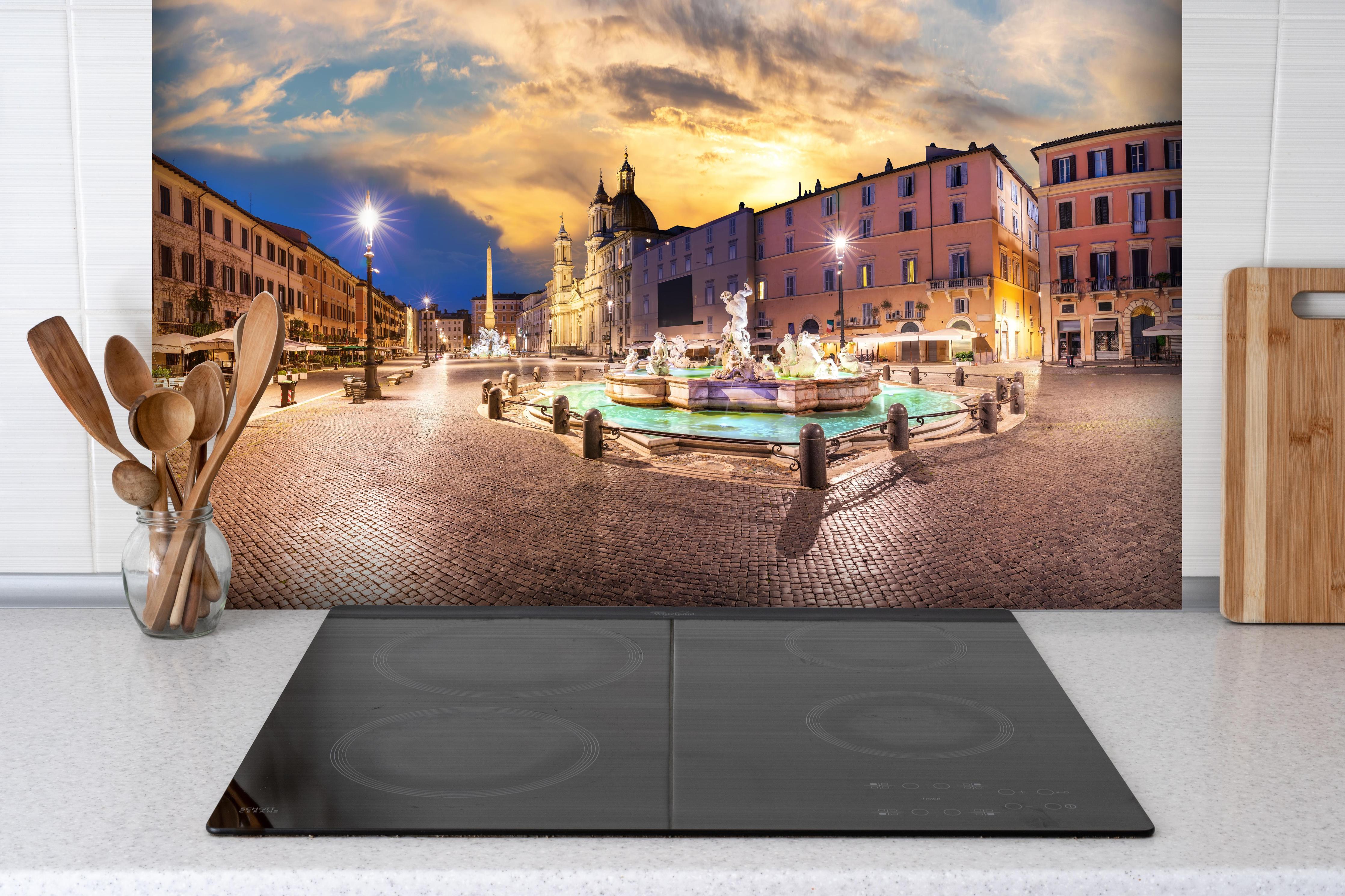 Spritzschutz - Neptunbrunnen auf der Piazza Navona hinter einem Cerankochfeld zwischen Holz-Kochutensilien