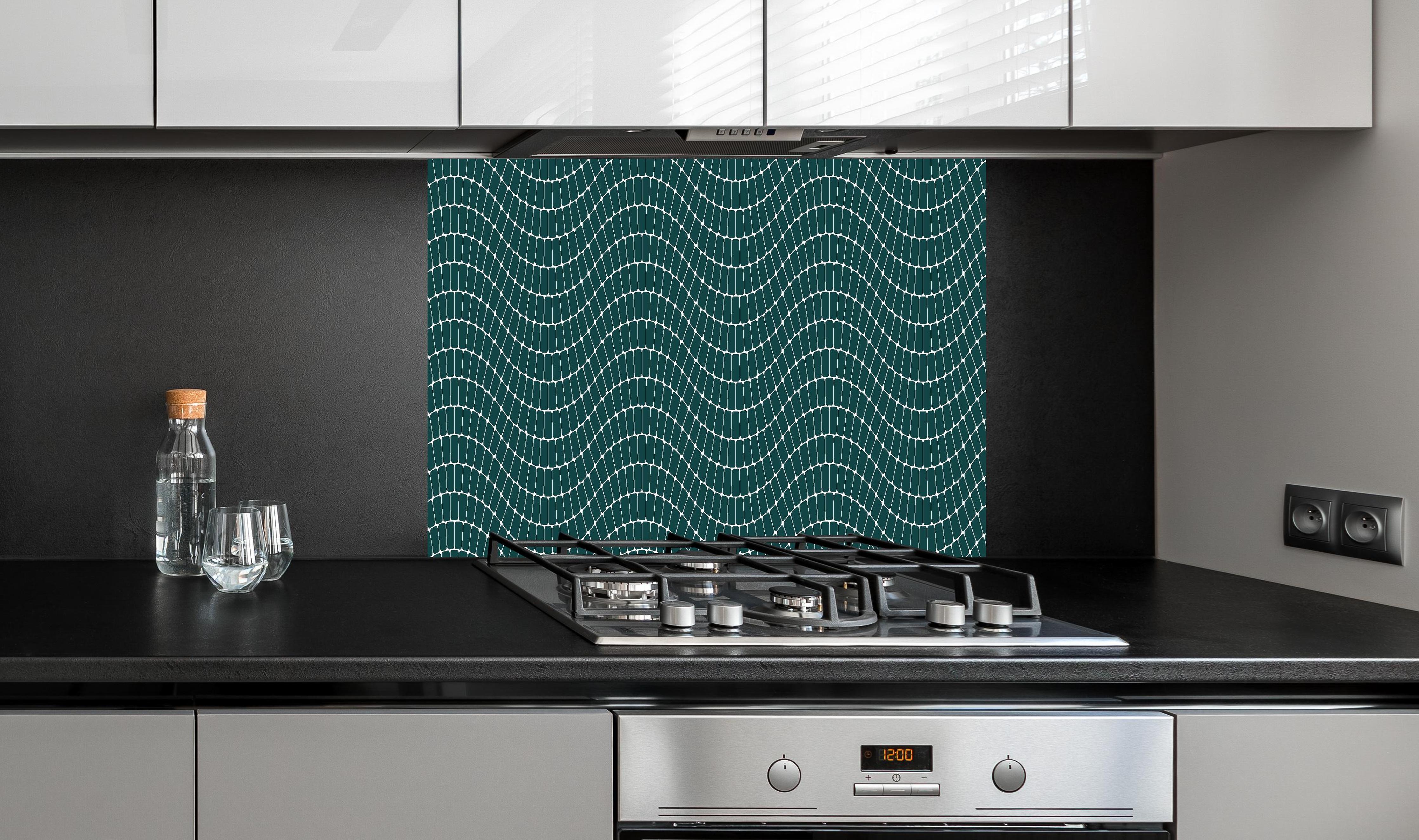 Spritzschutz - Onde Sinuoso Verde petrolio hinter einem Cerankochfeld zwischen Holz-Kochutensilien