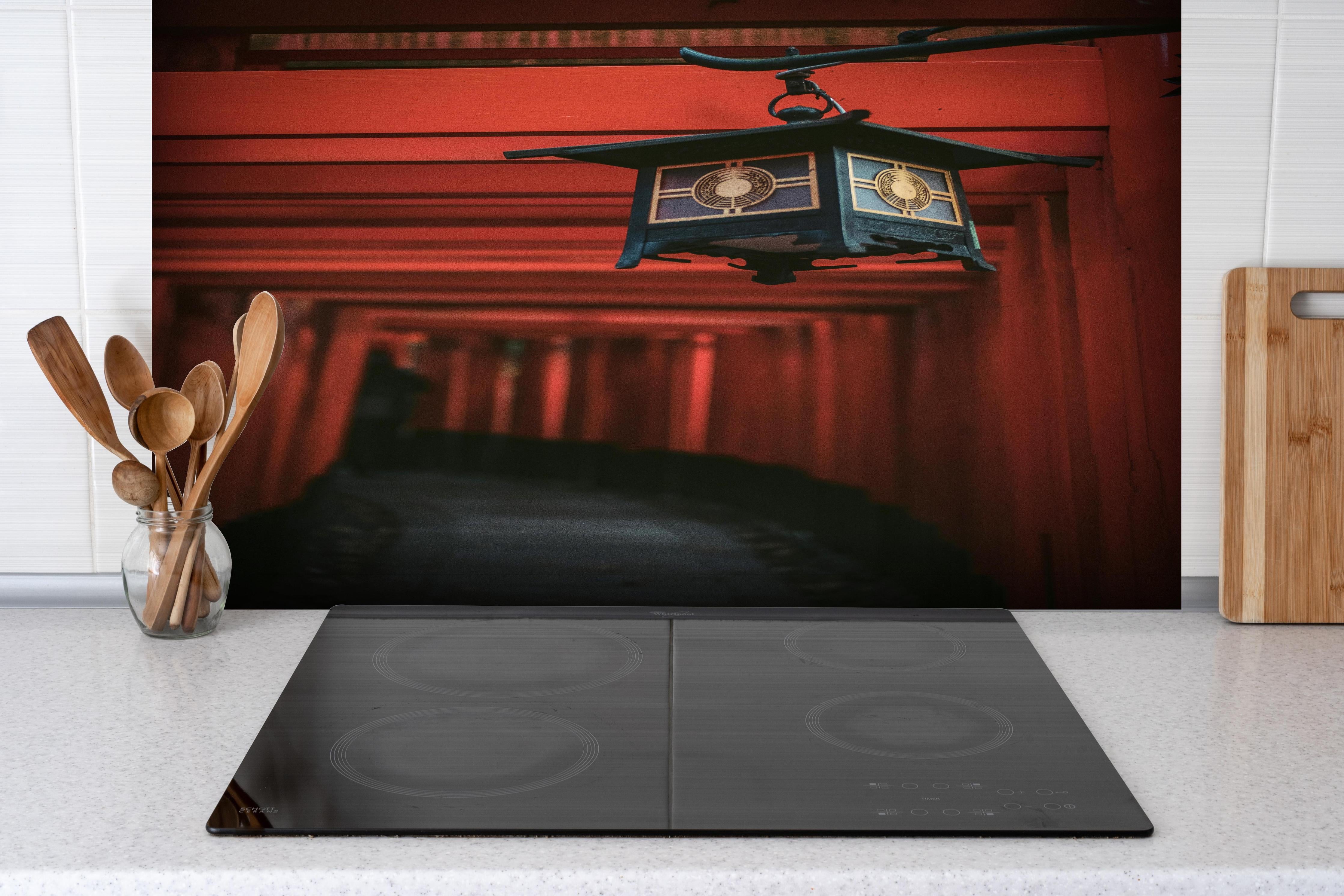 Spritzschutz - Orientalische Architektur hinter einem Cerankochfeld zwischen Holz-Kochutensilien