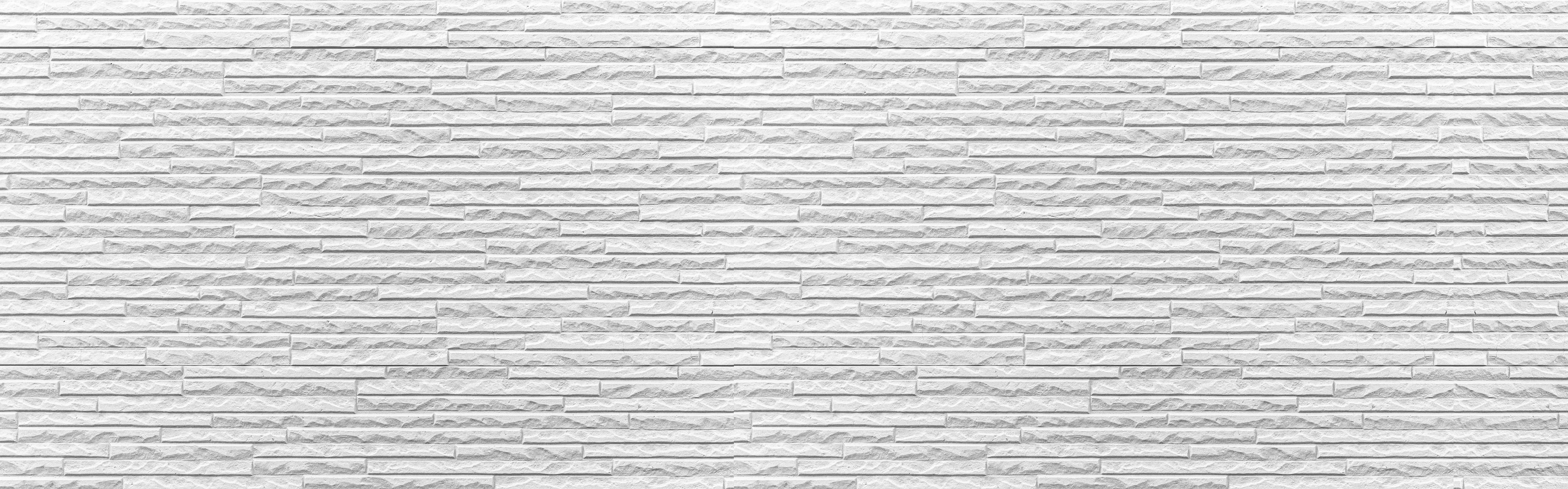 Spritzschutz-Panorama der weißen Steinwand