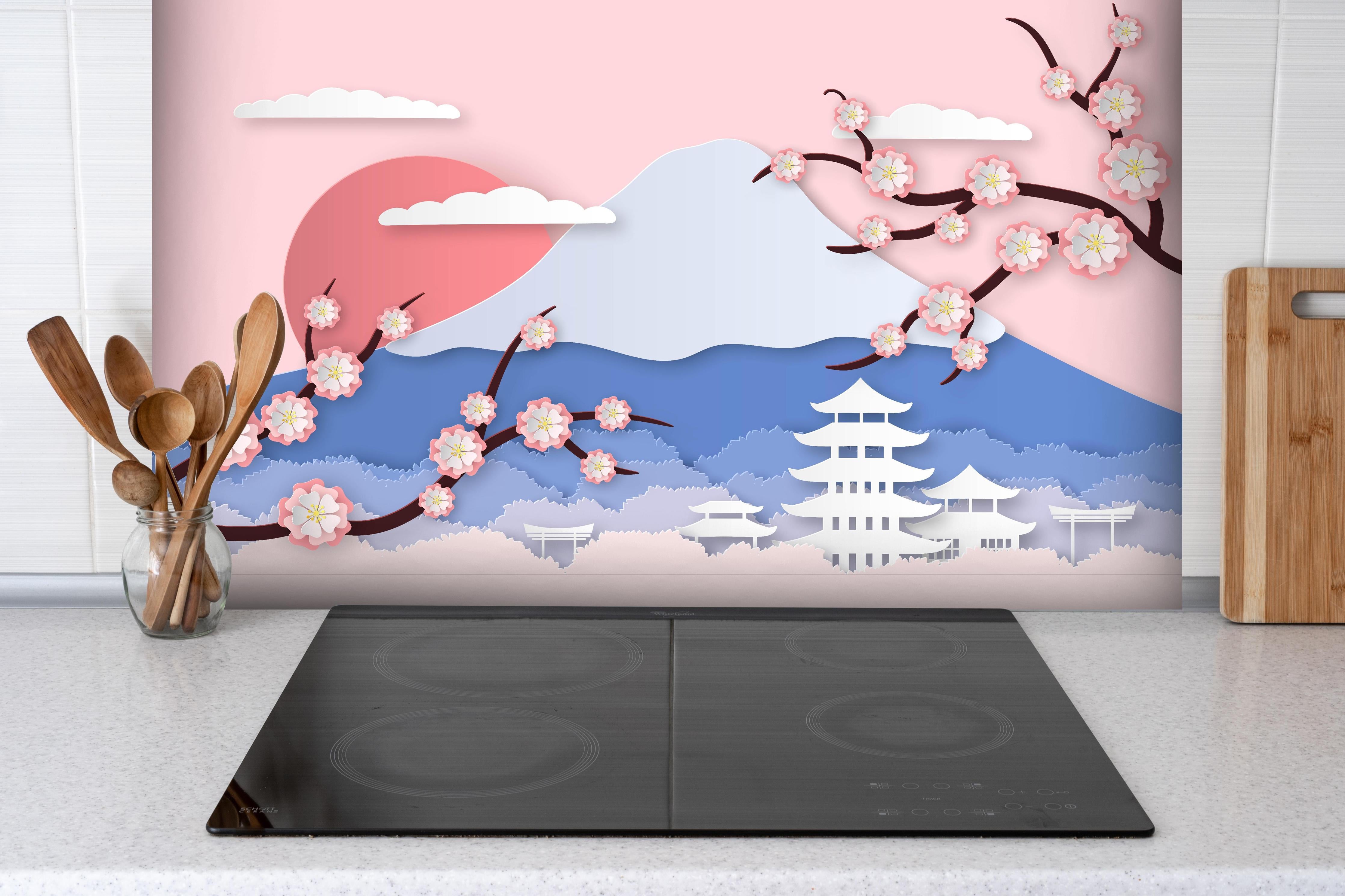 Spritzschutz - Papierkunst Japan Berge Sakura Sonnenuntergang hinter einem Cerankochfeld zwischen Holz-Kochutensilien