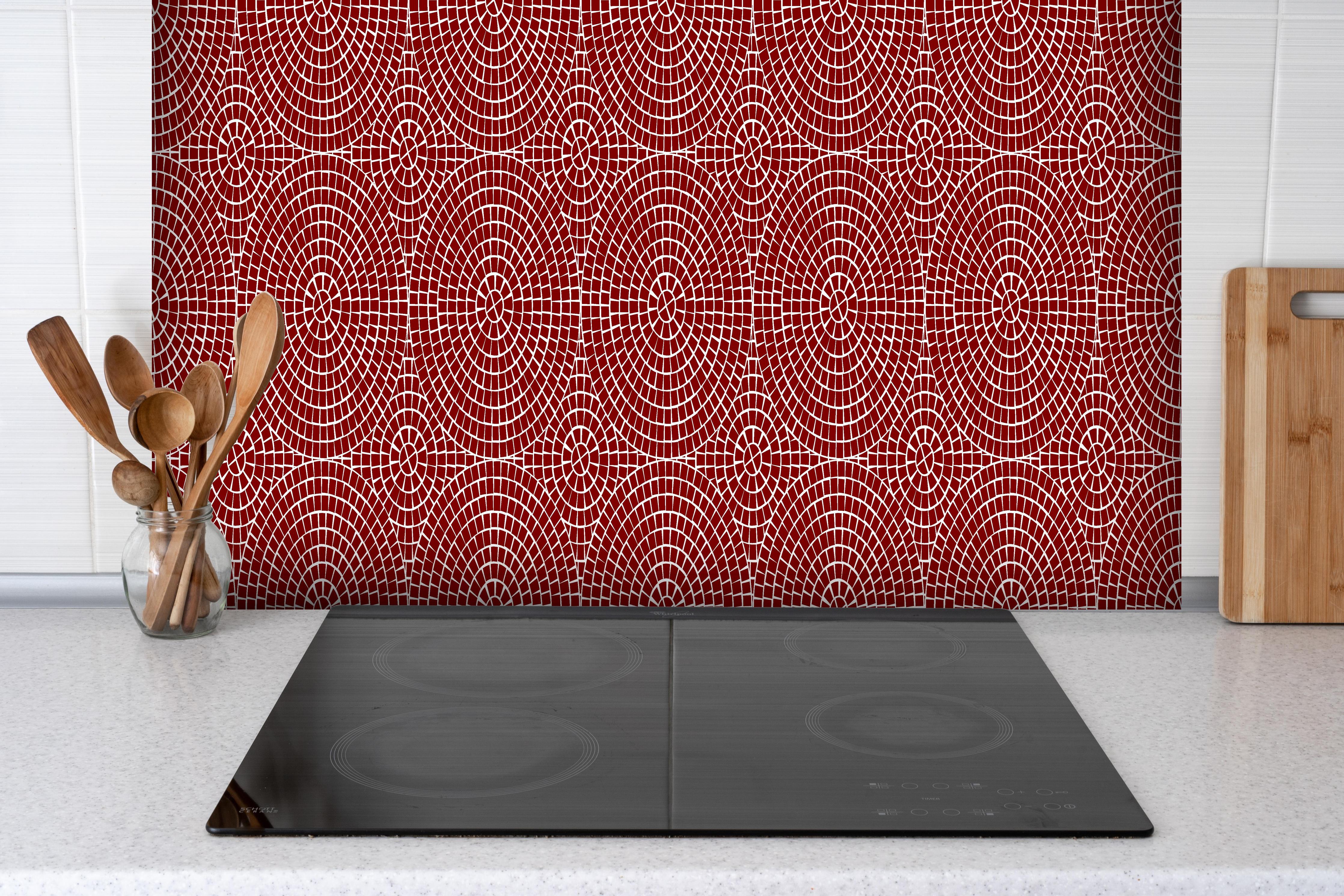 Spritzschutz - Pietre Mosaico Granata hinter einem Cerankochfeld zwischen Holz-Kochutensilien