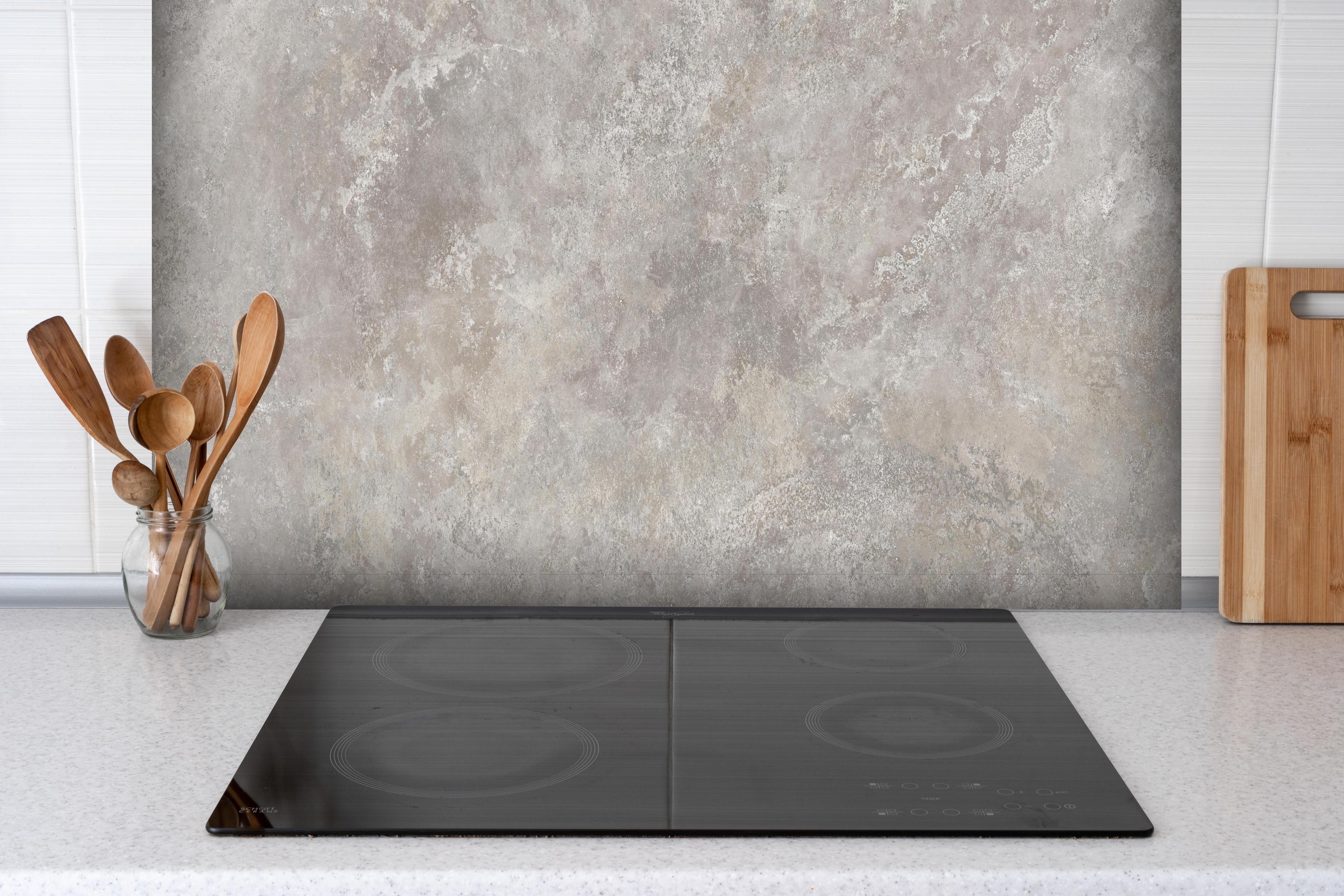 Spritzschutz - Raue Zement Struktur hinter einem Cerankochfeld zwischen Holz-Kochutensilien