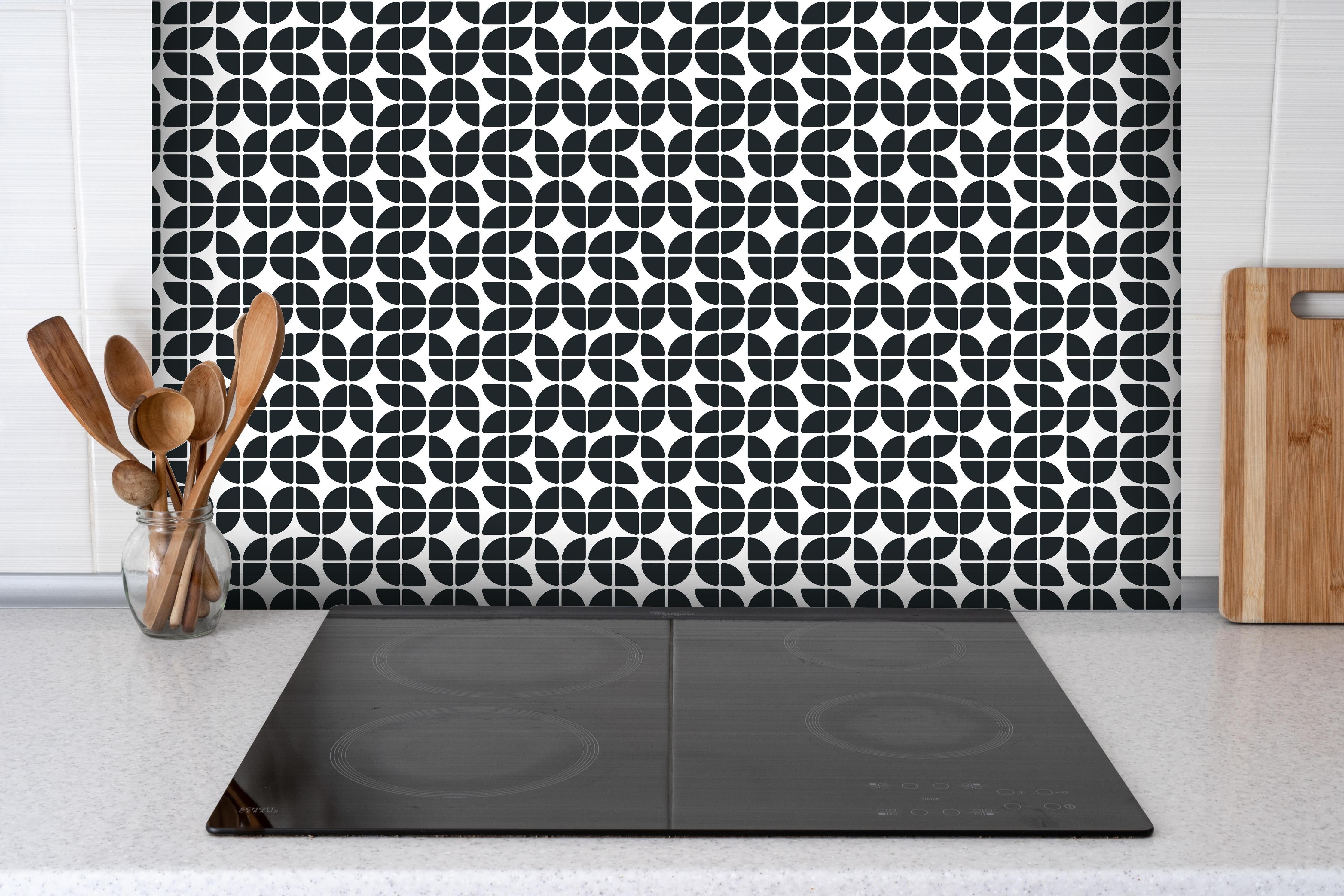 Spritzschutz - Retro Grazia Carbone hinter einem Cerankochfeld zwischen Holz-Kochutensilien