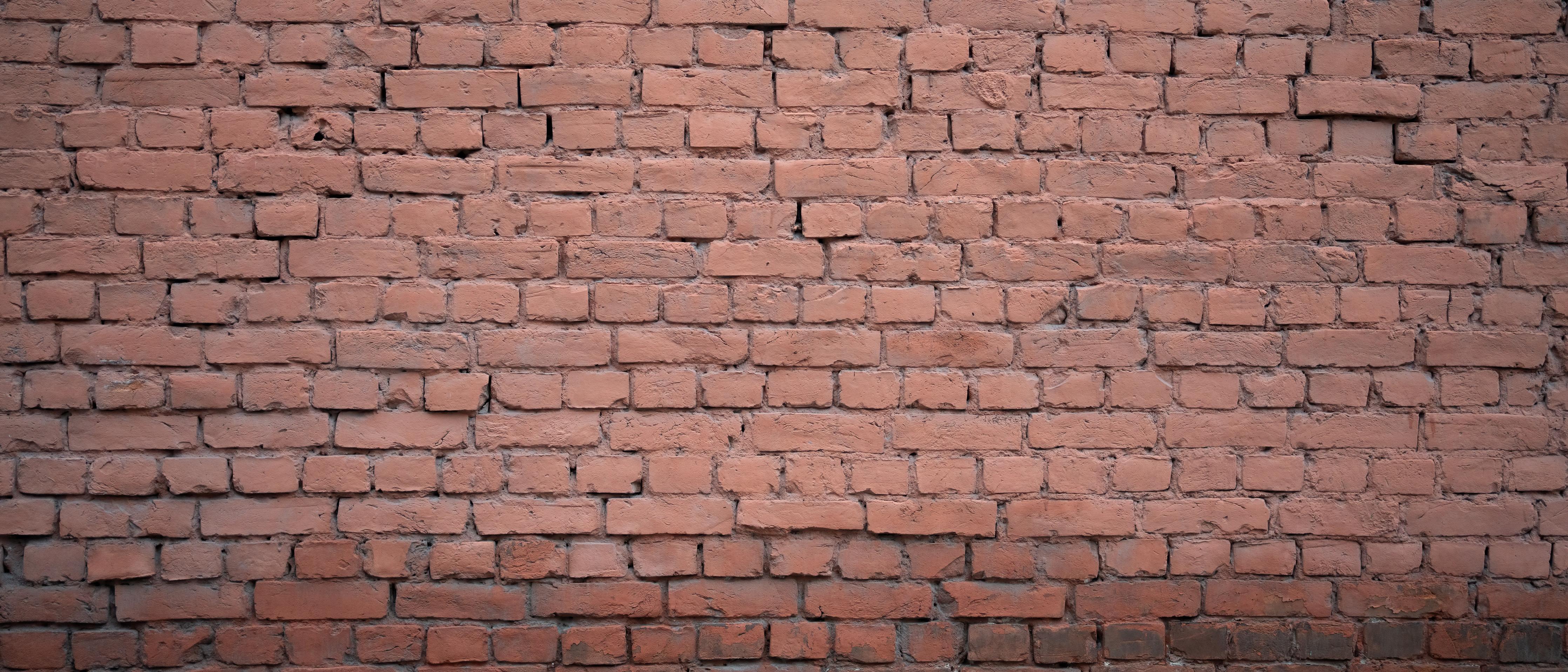 Spritzschutz-Rosafarbige Ziegelwandoberfläche