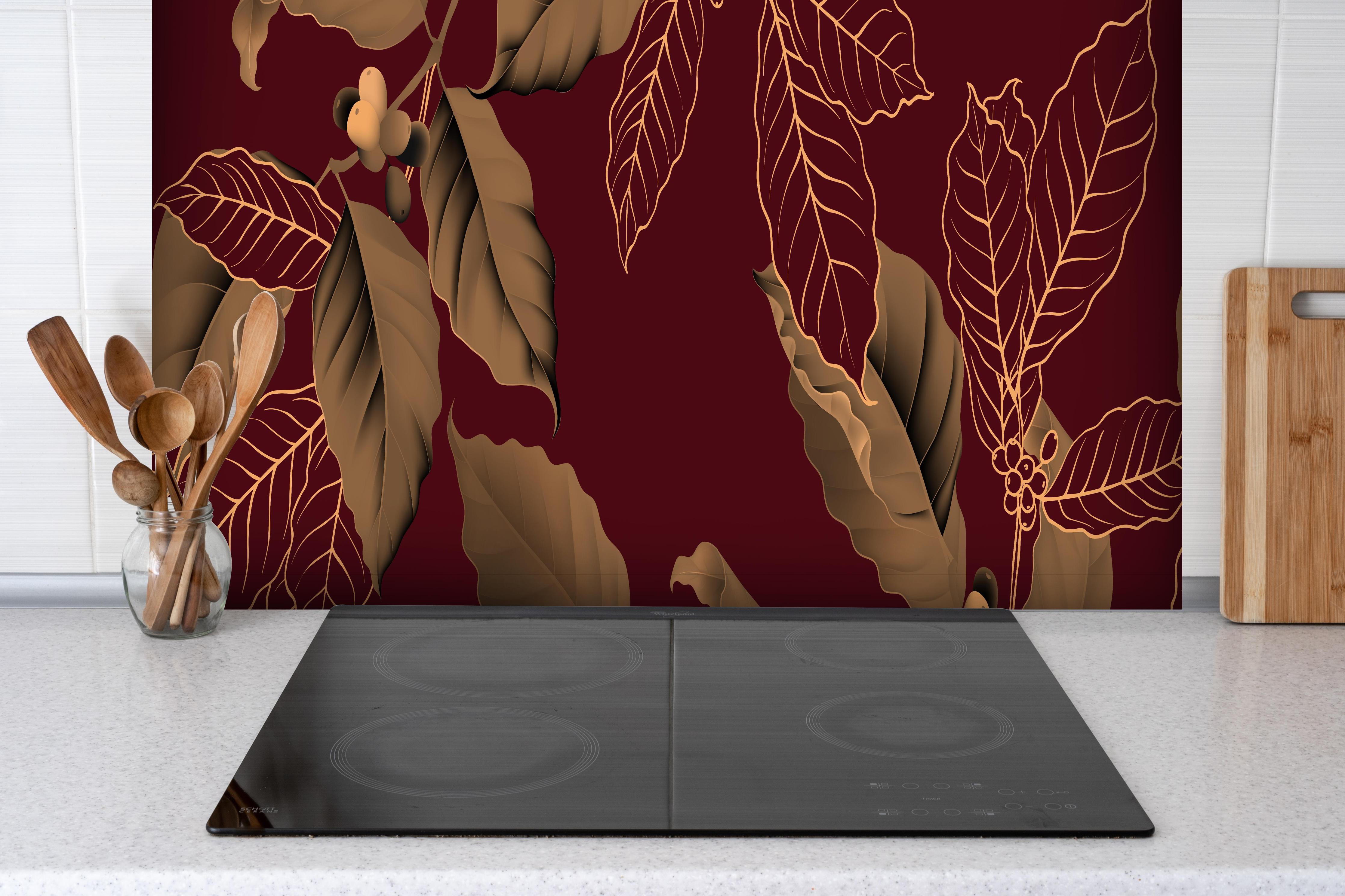 Spritzschutz - Rot-Braune Blätter hinter einem Cerankochfeld zwischen Holz-Kochutensilien