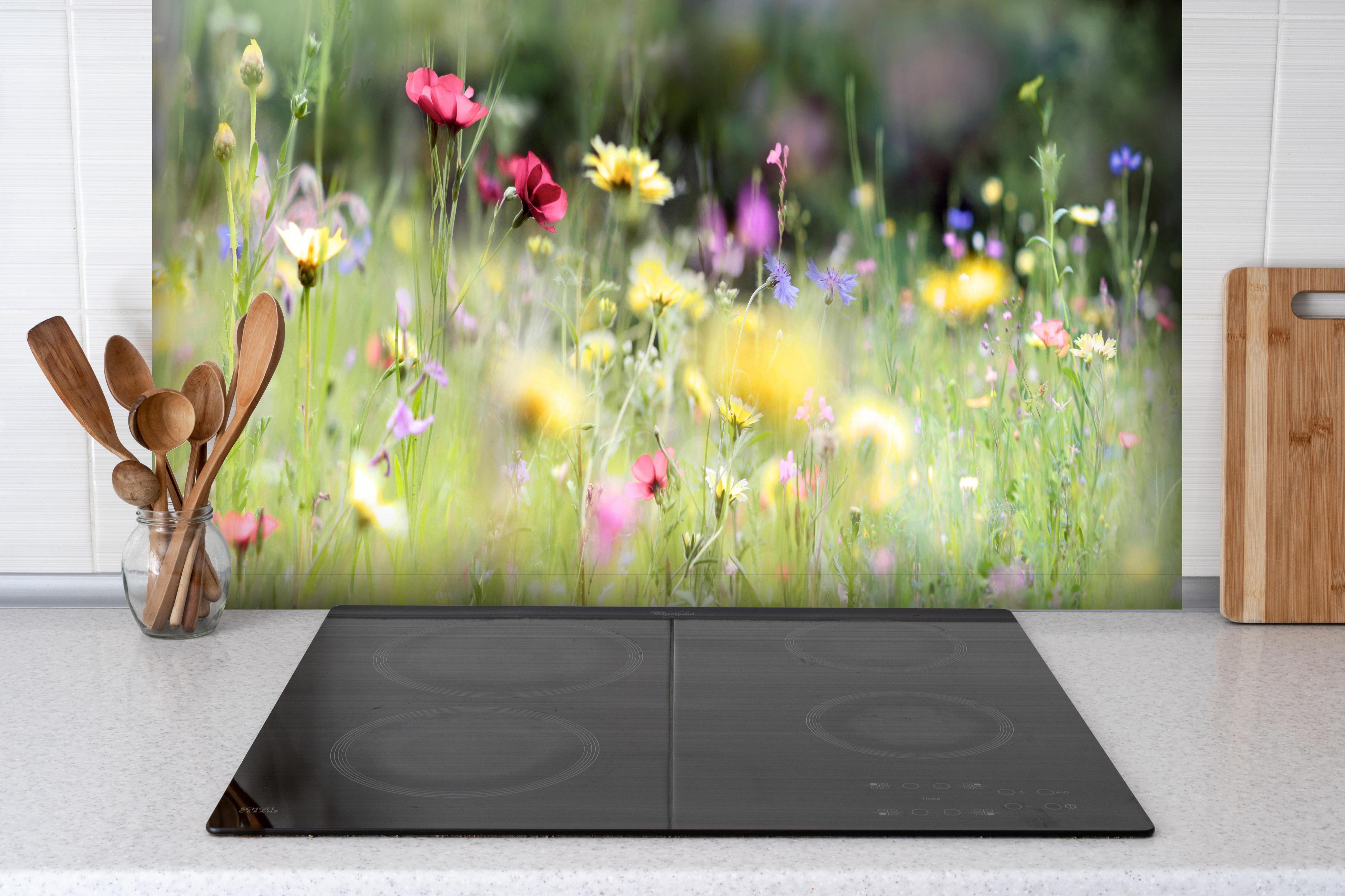 Spritzschutz - Schöne Wildblumenwiese hinter einem Cerankochfeld zwischen Holz-Kochutensilien