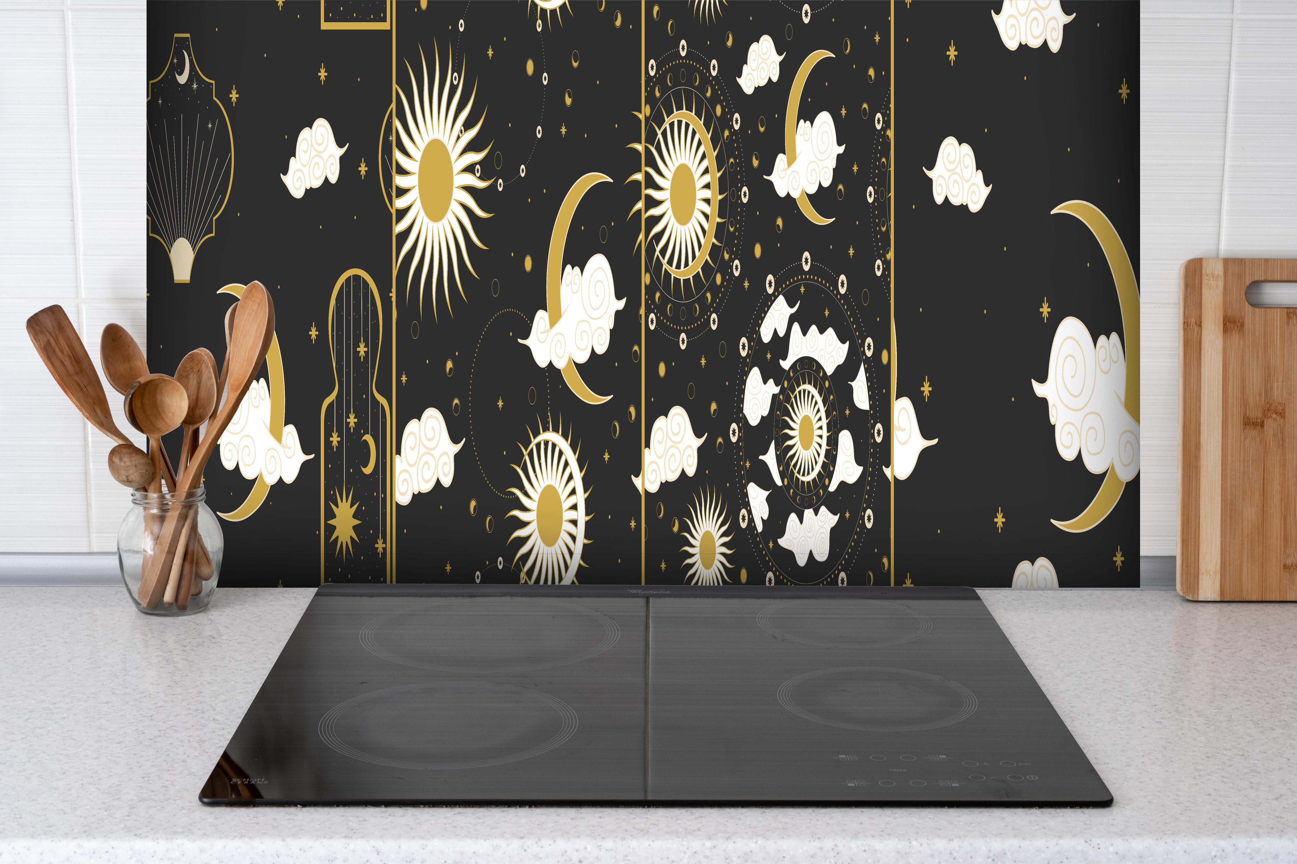 Spritzschutz - Schwarzer Hintergrund mit goldenem Himmel hinter einem Cerankochfeld zwischen Holz-Kochutensilien